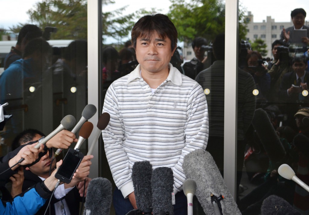 Father of Yamato Tanooka, a seven-year-old boy missing since being abandoned in a bear-inhabited forest in northern Japan, speaks to reporters in Hakodate on June 3, 2016. The boy, apparently unharmed and in good health, was discovered at a military base. Reports said he had taken shelter in a hut and found a tap to drink from but was hungry and immediately asked for food when discovered. / AFP PHOTO / JIJI PRESS / JIJI PRESS / Japan OUT