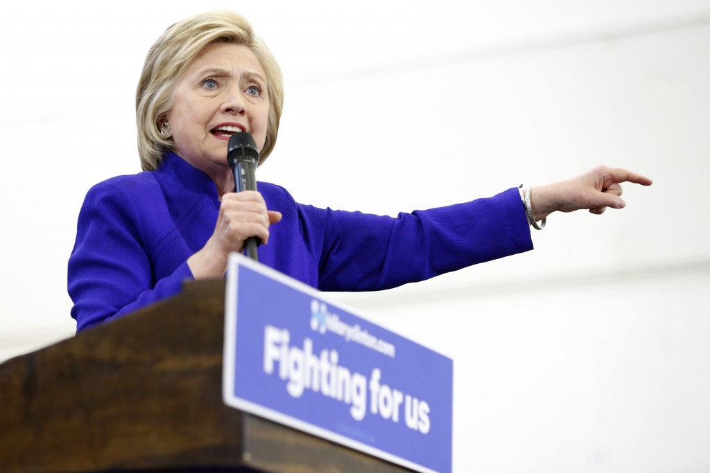 Hillary Clinton addresses supporters at Long Beach City College on the final day of California campaigning, June 6, 2016 in Long Beach, California. Hillary Clinton has received commitments from enough delegates to clinch the Democratic presidential nomination, according to the Associated Press and US networks, ensuring she will be the first woman to lead a major US party in the race for the White House. / AFP PHOTO / JONATHAN ALCORN