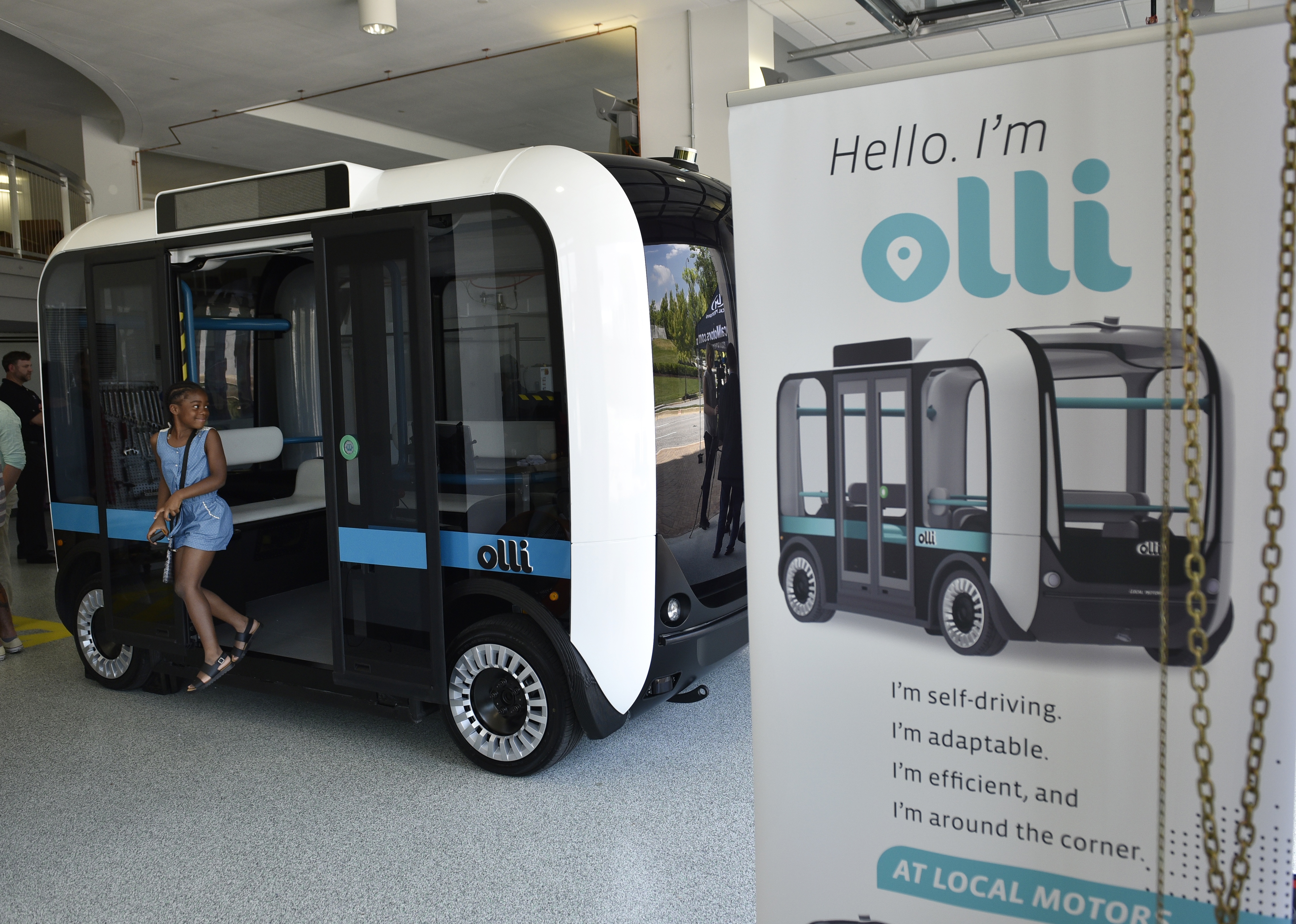 "Olli" an autonomous shuttle is seen at the Local Motors facility at the National Harbor in Maryland on June 16, 2016. The electric self-driving shuttle is partnership between Local Motors and IBM, using IBM's Watson supercomputer. / AFP PHOTO / Mandel Ngan
