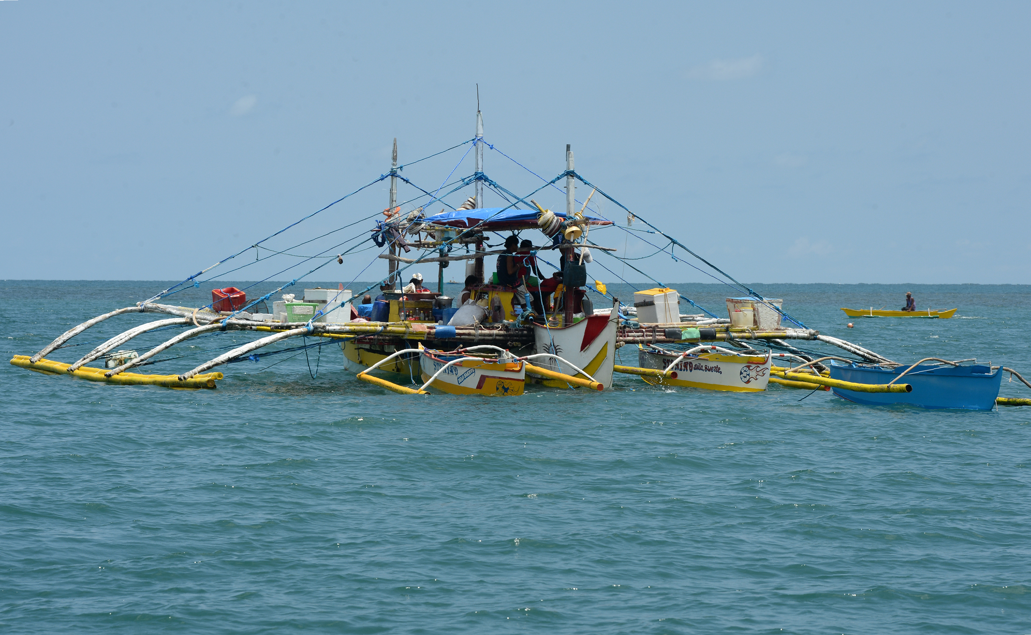 This photo taken on June 16, 2016 shows a fishing vessel anchored at the mouth of the South China Sea off the town of Infanta in Pangasinan province, as they wait for their fishing expedition to Scarborough Shoal. A recent incident at the nearby Scarborough Shoal, a necklace of reefs and rocks some 230 kilometres (140 miles) off the main Philippine island of Luzon that Filipino fishermen say hosts some of the world's most abundant marine life, is part of a long-running territorial row that sits at the heart of a UN backed tribunal expected to rule in the coming weeks. / AFP PHOTO / TED ALJIBE / TO GO WITH Philippines-China-UN-maritime-diplomacy-fishing,FOCUS by Cecil Morella