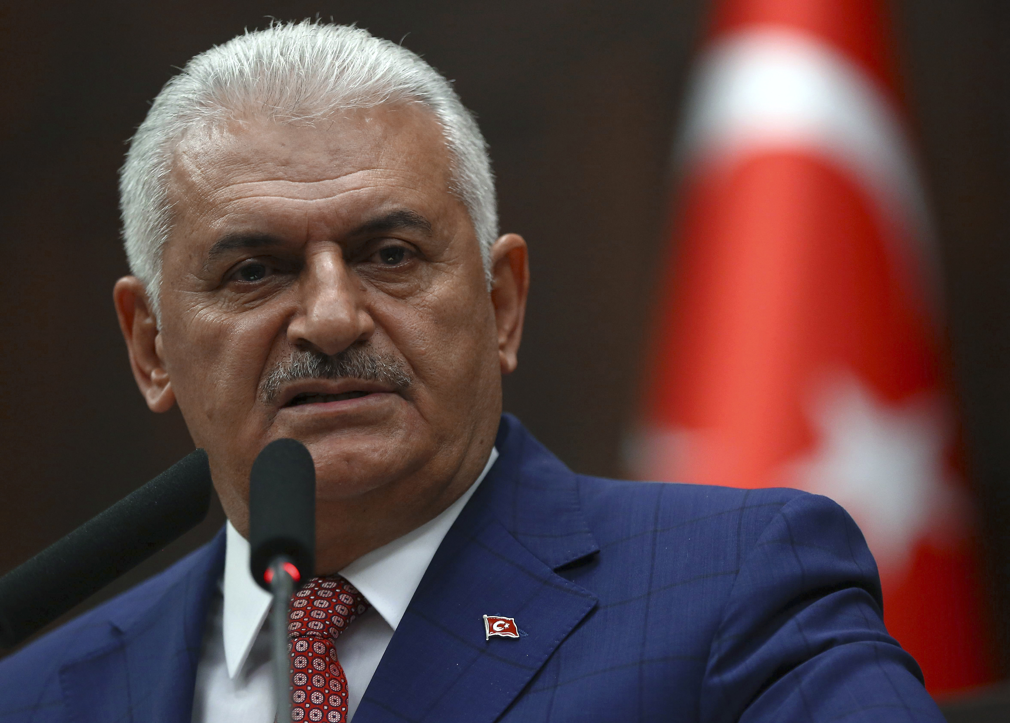 Turkish Prime Minister and leader of Turkey's ruling party, the Justice and Development Party (AK Party) Binali Yildirim addresses MPs during an AK Party's group meeting at the Grand National Assembly of Turkey (TBMM) in Ankara on June 21, 2016. / AFP PHOTO / ADEM ALTAN