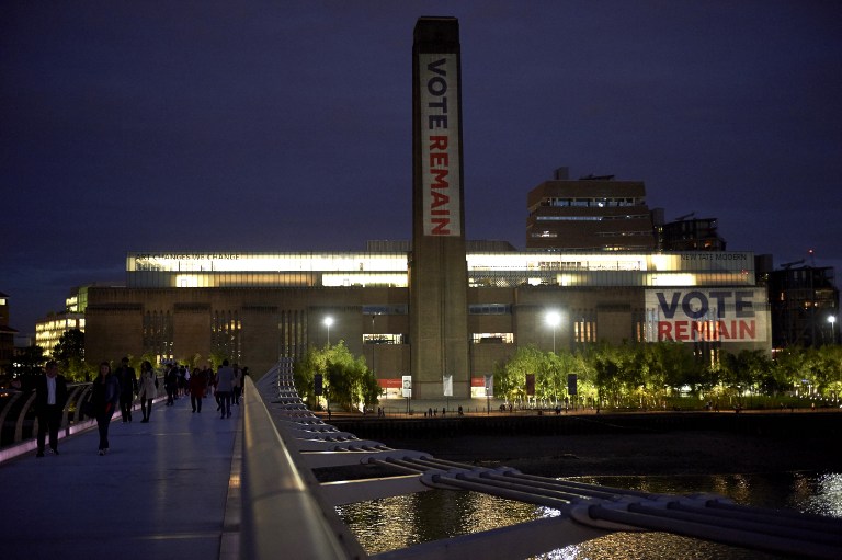 'Vote Remain' is projected onto the exterior of Tate Modern, ahead of Thursday's EU referendum, in central London on June 21, 2016. Prime Minister David Cameron pleaded with Britons Tuesday to think of their children and their economic well-being before voting to quit the EU, as polls showed a razor-tight race with less than 48 hours before the referendum. / AFP PHOTO / Niklas HALLE'N