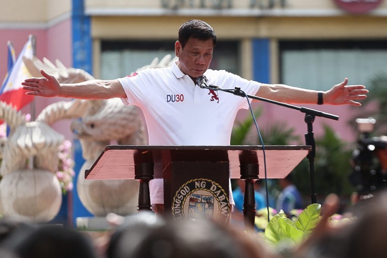 Philippines' president-elect Rodrigo Duterte gestures as he delivers his speech before city hall employees in Davao City, in the southern island of Mindanao on June 27, 2016, three days before taking oath as president. Incoming Philippine president Rodrigo Duterte on June 27 hit out at "stupid" human rights campaigners, as he defended his imminent war on crime and emphasised the death penalty was for retribution. / AFP PHOTO / MANMAN DEJETO