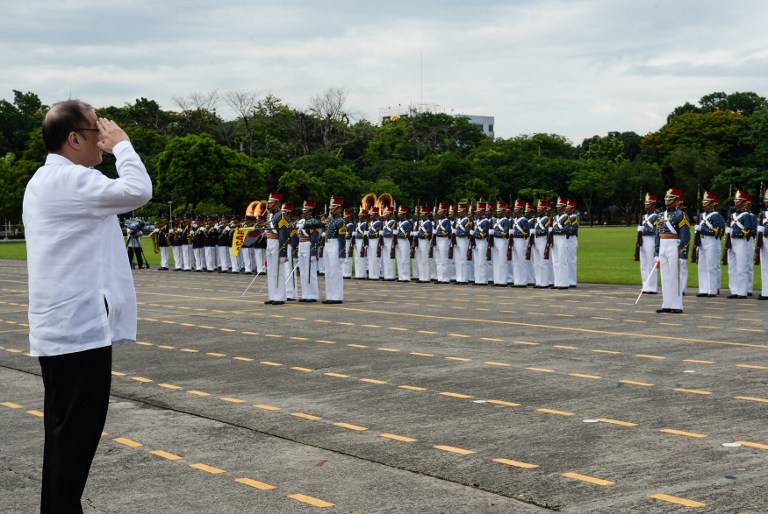 Philippines' outgoing president Benigno Aquino salutes during the testimonial parade for him at the military headquarters in Manila on June 27, 2016.  / AFP PHOTO / TED ALJIBE