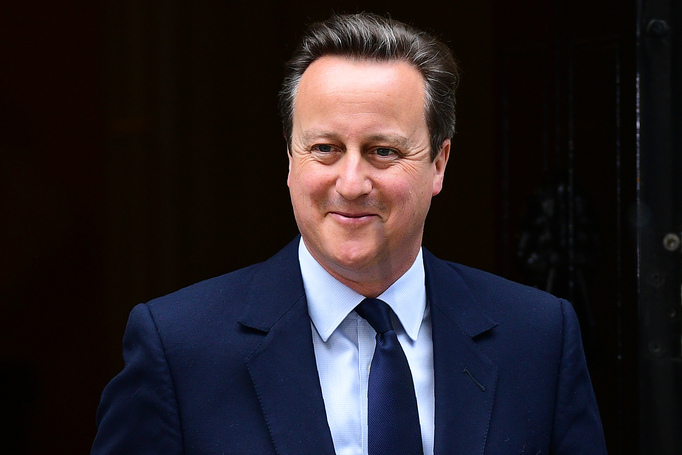 British Prime Minister David Cameron reacts as he departs 10 Downing Street enroute to the Houses of Parliament in central London on June 27, 2016. The British government on Monday agreed to establish a new civil service unit that will have the complex task of negotiating the country's departure from the European Union, outgoing Prime Minister David Cameron's spokeswoman said. London stocks extended their losses in early afternoon Monday, led by banking, airline and property shares, following Britain's vote to leave the EU. / AFP PHOTO / LEON NEAL