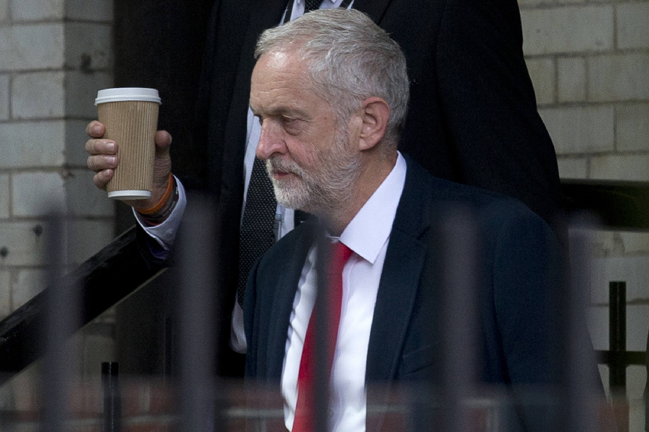 British opposition Labour Party Leader, Jeremy Corbyn makes his way from Portcullis House to the Houses of Parliament in London on June 27, 2016. Top Brexit campaigner Boris Johnson sought Monday to build bridges with Europe and with defeated Britons who voted to remain in the EU in last week's historic referendum. London stocks sank more than 0.8 percent in opening deals on Monday, despite attempts by finance minister George Osborne to calm jitters after last week's shock Brexit vote. / AFP PHOTO / JUSTIN TALLIS