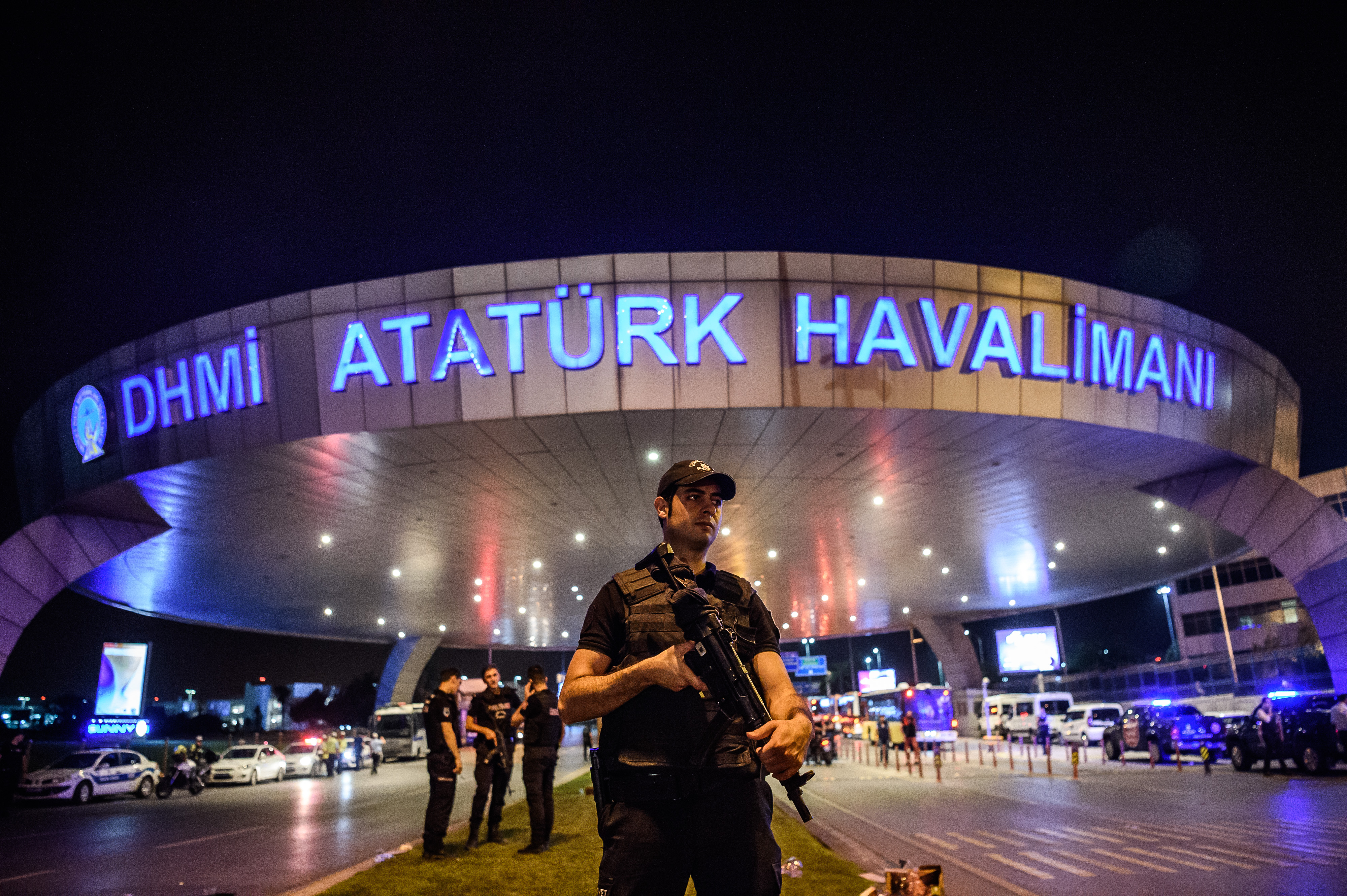 A Turkish riot police officer patrols Ataturk airport`s main enterance in Istanbul, on June 28, 2016, after two explosions followed by gunfire hit Turkey's largest airport, killing at least 10 people and injuring 20. All flights at Istanbul's Ataturk international airport were suspended on June 28, 2016 after a suicide attack left at least 36 people dead. / AFP PHOTO / OZAN KOSE