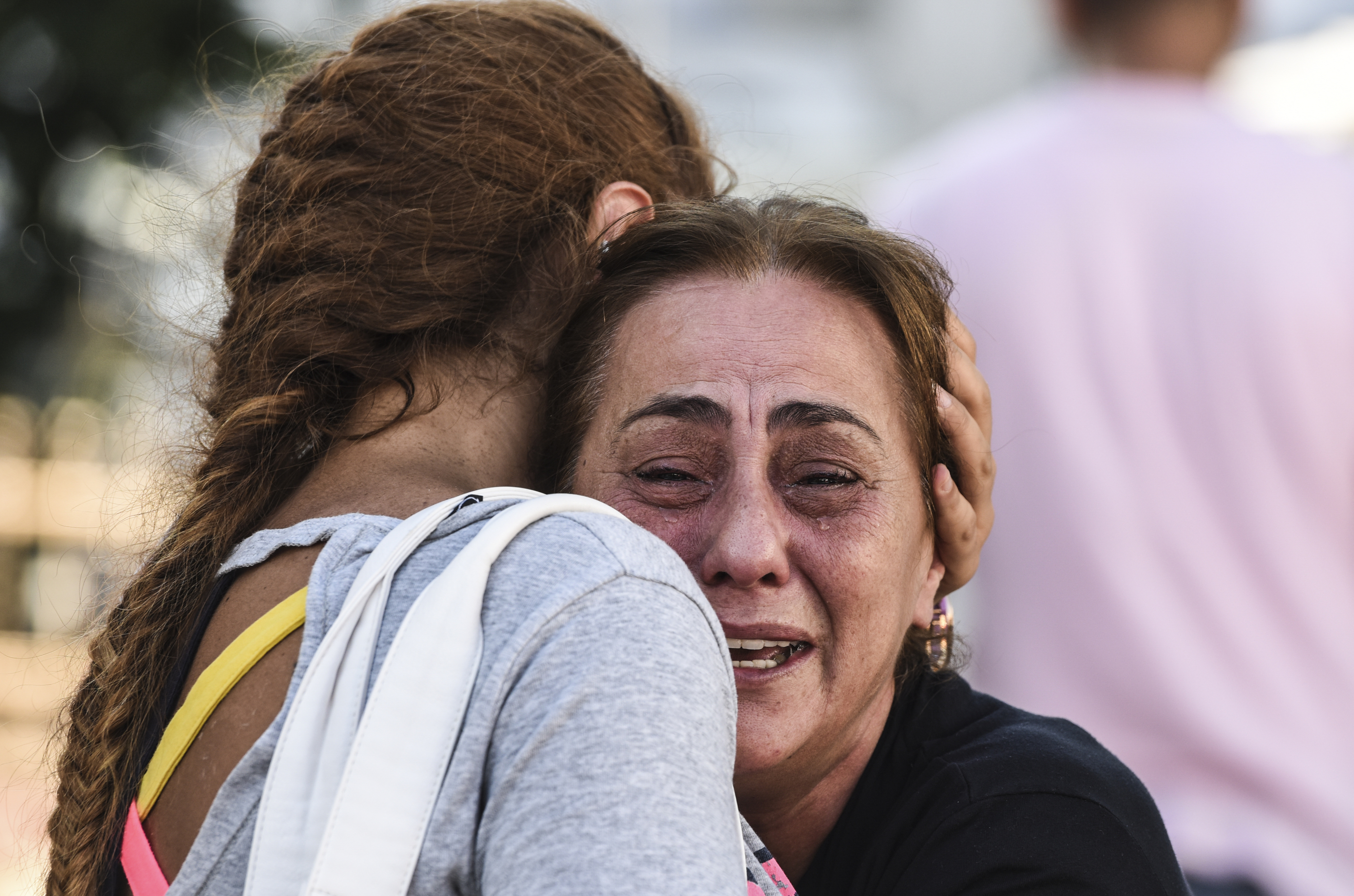 A mother of victims reacts outside a forensic medicine building close to Istanbul's airport on June 29, 2016, a day after a suicide bombing and gun attack targetted Istanbul's airport, killing at least 36 people. A triple suicide bombing and gun attack that occurred on June 28, 2016 at Istanbul's Ataturk airport has killed at least 36 people, including foreigners, with Turkey's prime minister saying early signs pointed to an assault by the Islamic State group. / AFP PHOTO / BULENT KILIC