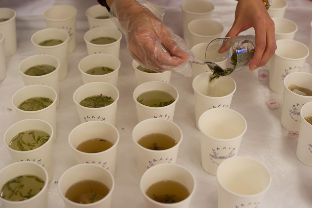 A hostess prepares green tea inside the lobby of the Great Hall of the People during the National People's Cogress (NPC) in Beijing on March 8, 2012. With 60 tables and over 3000 delegates and attending media passing through the the lobby of the Great Hall from the frigid temperatures of Tiananment square, the hostesses serve, prepare, and top-up tea-cups for for the duration of the annual congress. The 2012 NPC session is the last before a handover of power that begins later this year, and leaders are anxious to ensure the world's second-largest economy grows at a steady pace while keeping a lid on social unrest. AFP PHOTO / Ed Jones / AFP PHOTO / Ed Jones