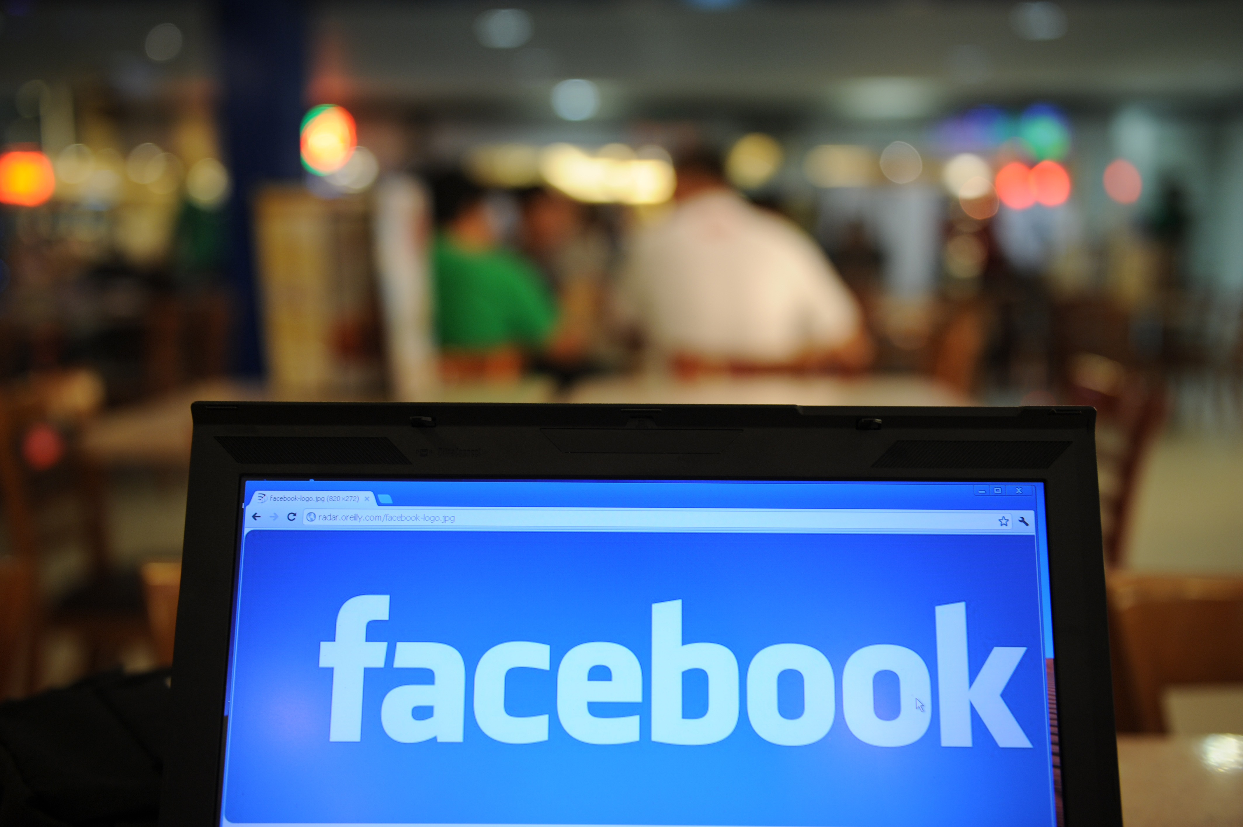 TO GO WITH US-IT-Internet-IPO-Facebook-Asia,FOCUS by Dan Martin In a picture taken on May 15, 2012, a logo of social networking facebook is displayed on a laptop screen inside a restaurant in Manila. As Facebook nears saturation levels in some Western countries, Asian users are helping drive the social-networking leader's march on the 1-billion-user milestone and beyond.  AFP PHOTO/TED ALJIBE / AFP PHOTO / TED ALJIBE