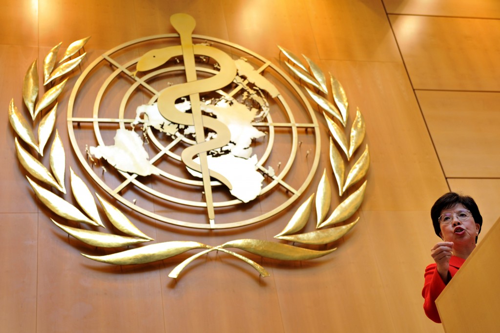 World Health Organisation (WHO) Director General Margaret Chan gestures with a giant WHO's logo as background during her speech before the WHO World health assembly's annual meeting on May 18, 2009 at the UN Offices in Geneva. The World Health Organisation is keeping its swine flu pandemic alert level at five, one below the maximum, WHO chief Margaret Chan said Monday. AFP PHOTO / FABRICE COFFRINI / AFP PHOTO / FABRICE COFFRINI