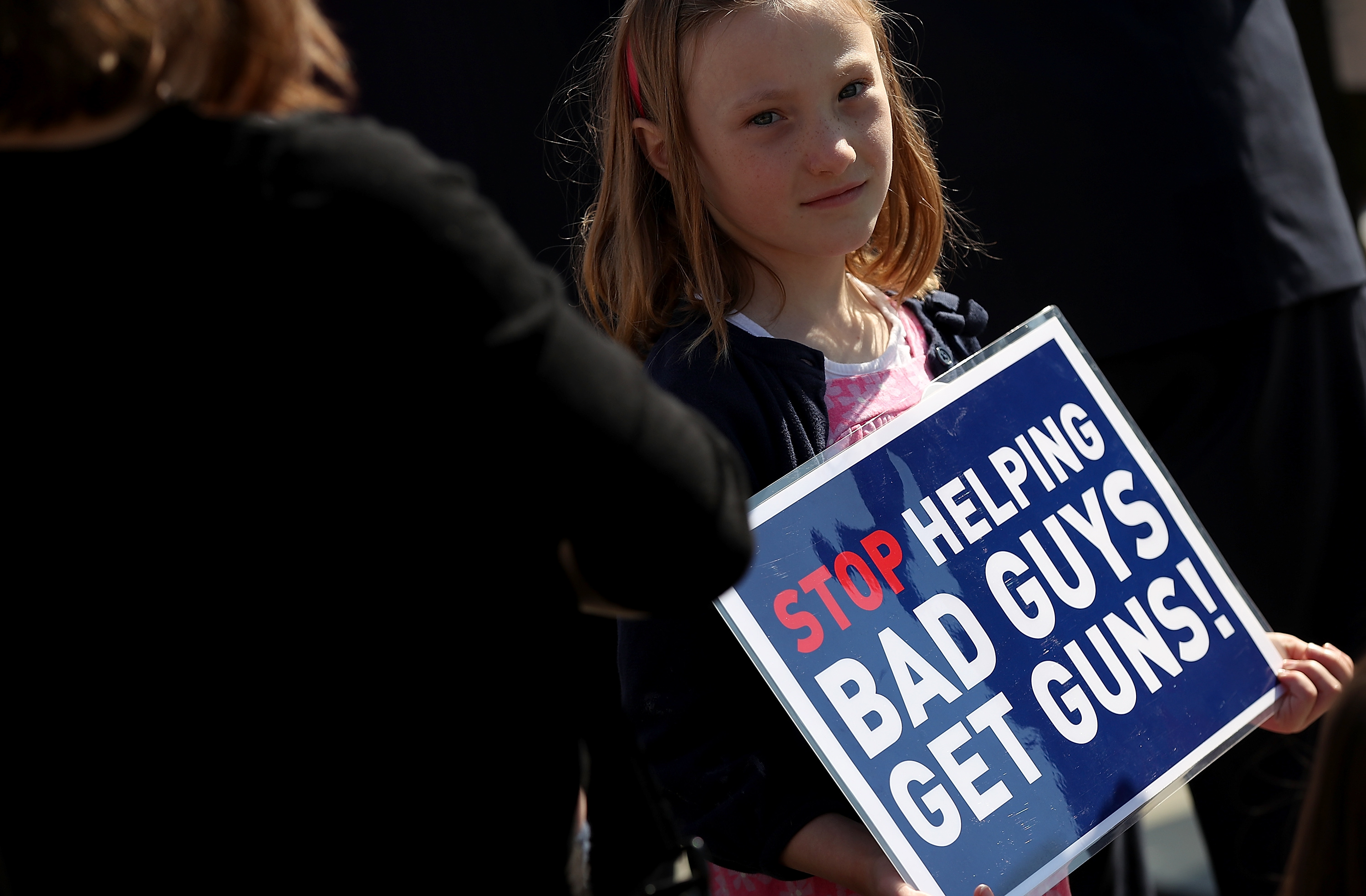 WASHINGTON, UNITED STATES - APRIL 14: A young girl joins gun reform advocates holding a news conference outside the U.S. Capitol April 14, 2016 in Washington, DC. Members of Congress joined the activists in calling for the repeal of the Protection of Lawful Commerce in Arms Act arguing that their position would "advance sensible, popular legislation to curb the epidemic of gun violence that kills 90 Americans every day." Win McNamee/Getty Images/AFP