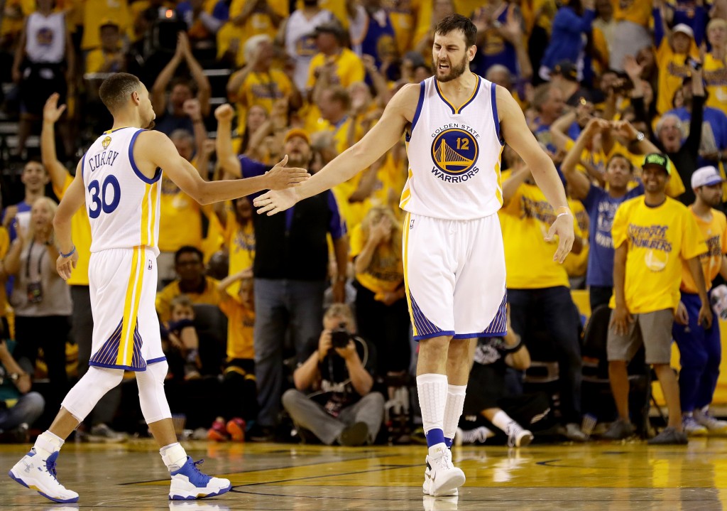 OAKLAND, CA - JUNE 05: Stephen Curry #30 and Andrew Bogut #12 of the Golden State Warriors react after a play against the Cleveland Cavaliers in Game 2 of the 2016 NBA Finals at ORACLE Arena on June 5, 2016 in Oakland, California. NOTE TO USER: User expressly acknowledges and agrees that, by downloading and or using this photograph, User is consenting to the terms and conditions of the Getty Images License Agreement. Ezra Shaw/Getty Images/AFP
