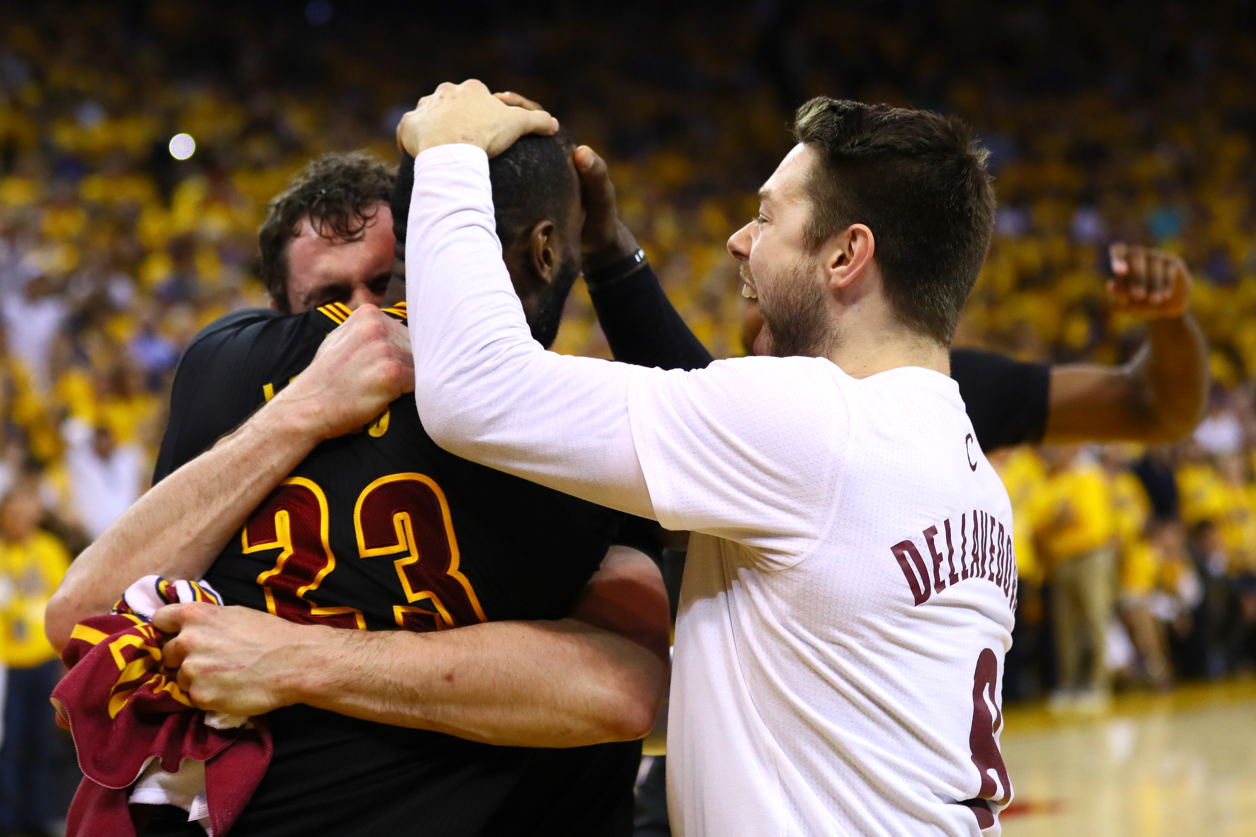 OAKLAND, CA - JUNE 19: LeBron James #23, Matthew Dellavedova #8 and Kevin Love #0 of the Cleveland Cavaliers celebrate after defeating the Golden State Warriors 93-89 in Game 7 of the 2016 NBA Finals at ORACLE Arena on June 19, 2016 in Oakland, California. NOTE TO USER: User expressly acknowledges and agrees that, by downloading and or using this photograph, User is consenting to the terms and conditions of the Getty Images License Agreement.   Ezra Shaw/Getty Images/AFP