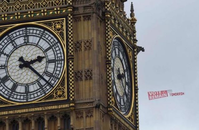 'Vote Remain' banner being flown by an aircraft is seen behind the Big Ben clocktower in London, Britain. REUTERS/TOBY MELVILLE