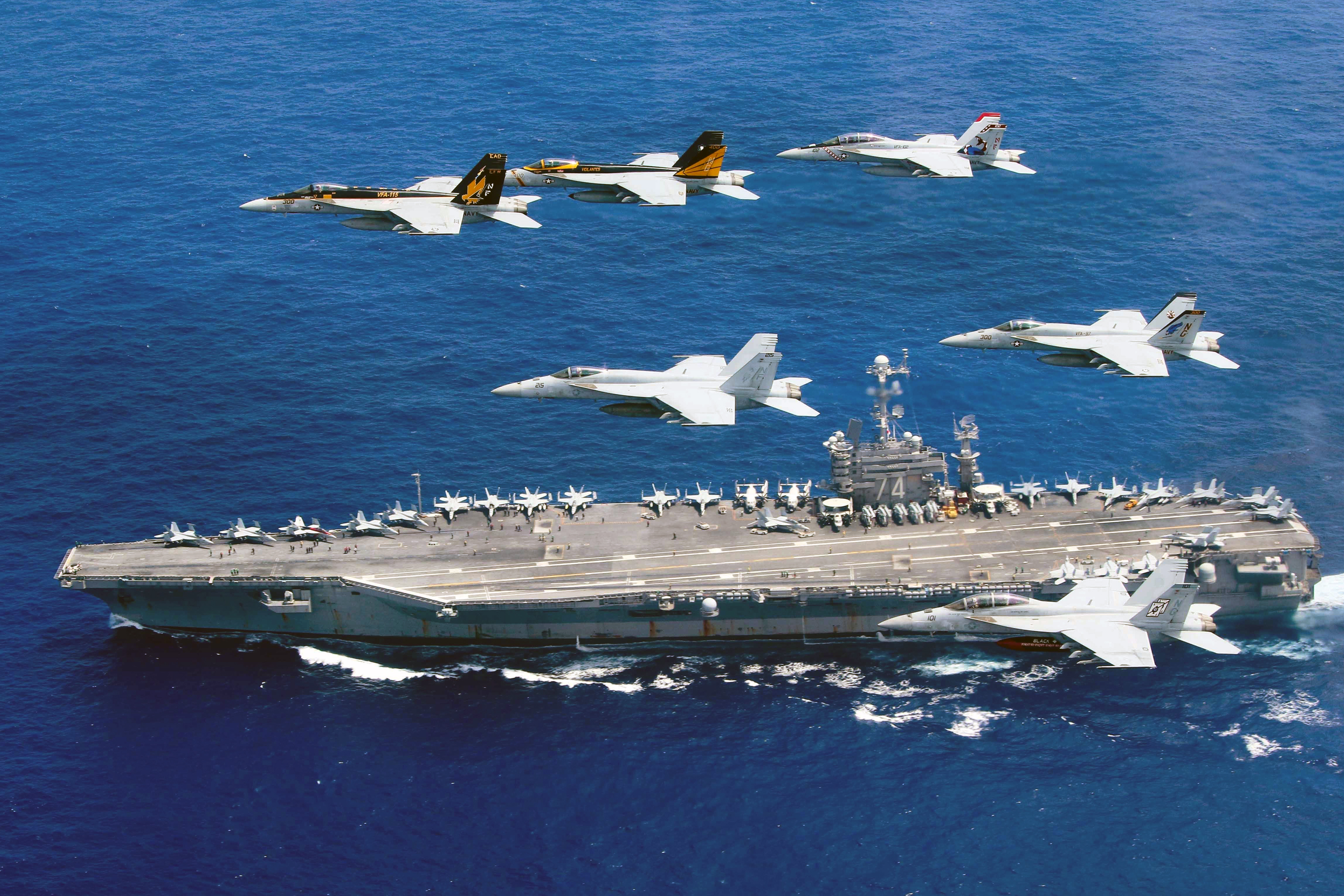 This photo taken on June 18, 2016 and released June 19, 2016 by the US Navy shows a flight formation of Boeing F/A-18E and F Super Hornets from Carrier Air Wing (CVW) 5 and 9 above the Nimitz-class aircraft carrier USS John C. Stennis (CVN-74) in the Philippine Sea. Two US aircraft carriers have started exercises in the Philippine Sea, defence officials said June 19, as Washington's close ally Manila faces growing pressure from Beijing in the South China Sea. / AFP PHOTO / US NAVY / STEVE SMITH / RESTRICTED TO EDITORIAL USE - MANDATORY CREDIT "AFP PHOTO / US NAVY / STEVE SMITH" - NO MARKETING NO ADVERTISING CAMPAIGNS - DISTRIBUTED AS A SERVICE TO CLIENTS