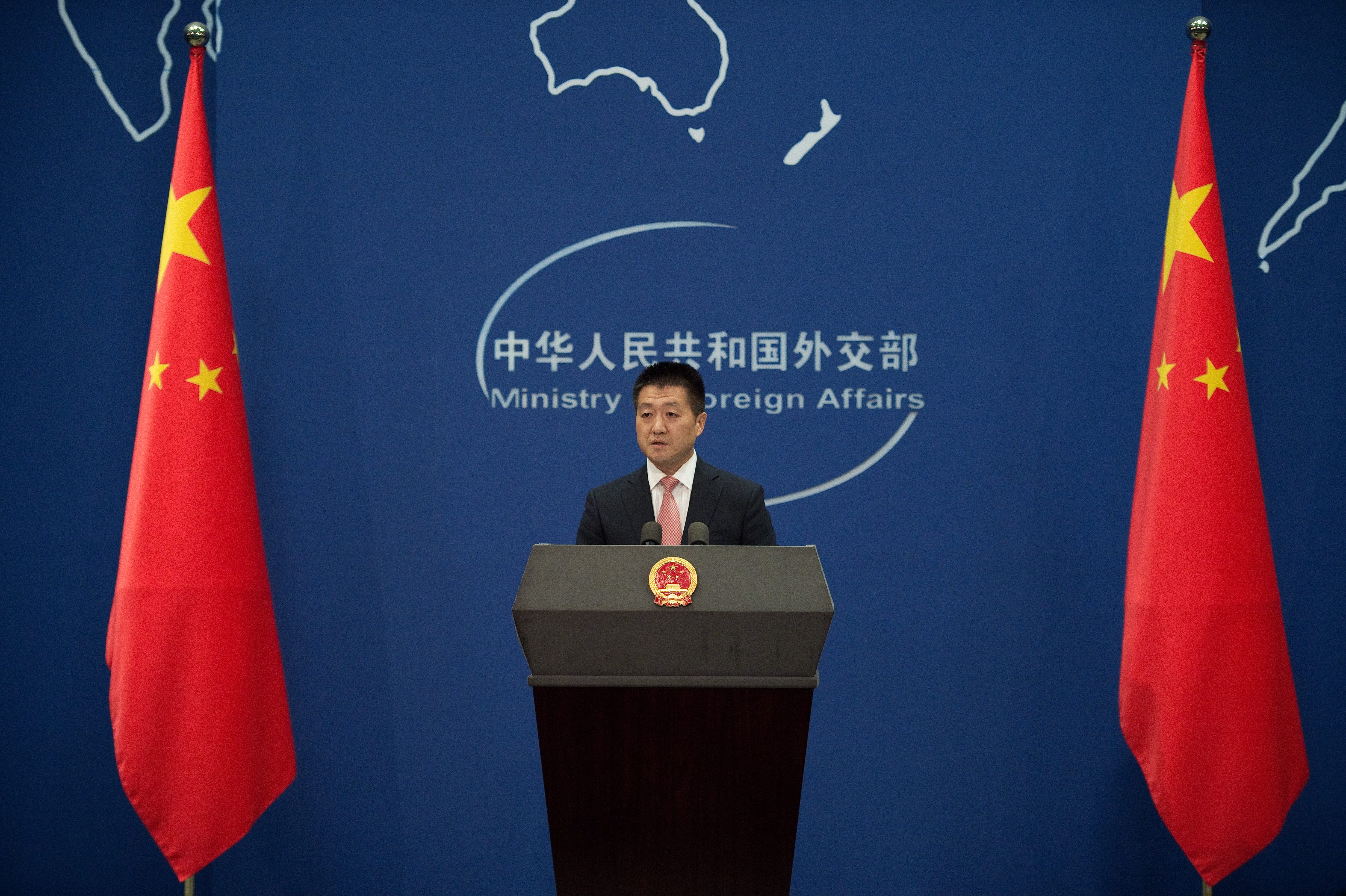 Chinese Foreign Ministry spokesman Lu Kang speaks to the media during a press conference in Beijing on July 13, 2016. China warned its rivals against turning the South China Sea into a "cradle of war" and threatened an air defence zone there, after its claims to the strategically vital waters were declared invalid. / AFP PHOTO / NICOLAS ASFOURI