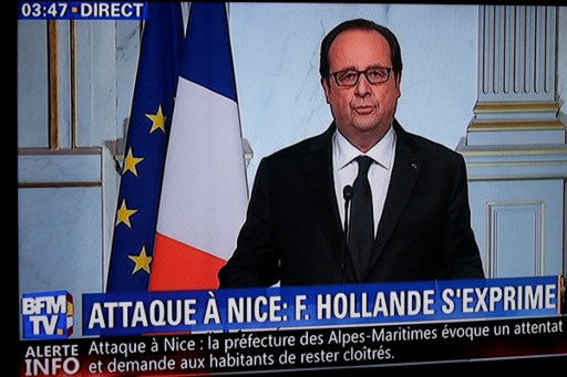This still image from a BFM TV telecast shows French President Francois Hollande speaking about the attack in Nice on July 14, 2016 in Elysee, Paris.  A truck ploughed into a crowd in the French Riviera resort of Nice, killing at least 77 and injuring scores in what President Francois Hollande Friday called a "terrorist" attack on revellers watching a Bastille Day fireworks display.  / AFP PHOTO / BFM TV / GEOFFROY VAN DER HASSELT