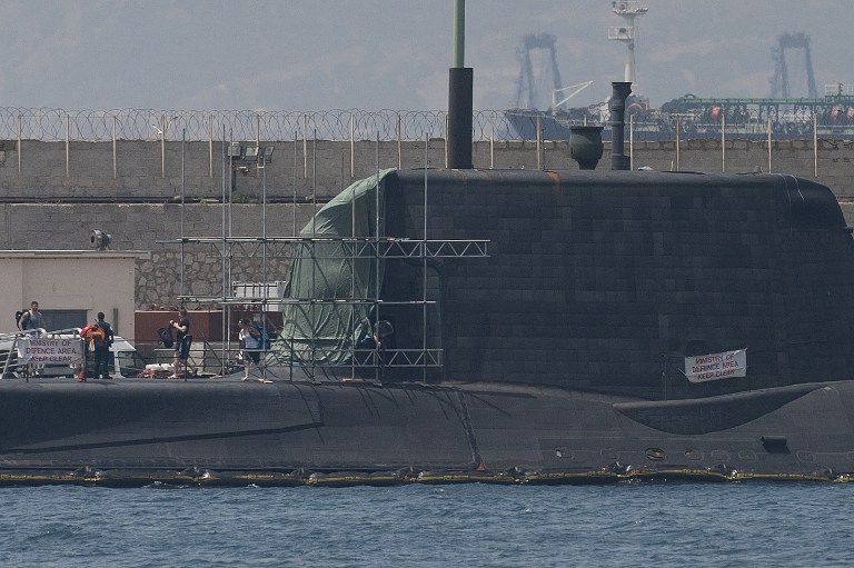 A picture taken on July 21, 2016 shows the nuclear submarine HMS Ambush moored in the port of Gibraltar during an unscheduled stop due to a sustained damage to its conning tower after hitting a vessel. The HMS Ambush submarine was submerged and carrying out a training exercise in Gibraltar waters when it collided with the vessel on July 20, 2016 afternoon, damaging the front of its conning tower. / AFP PHOTO / JORGE GUERRERO