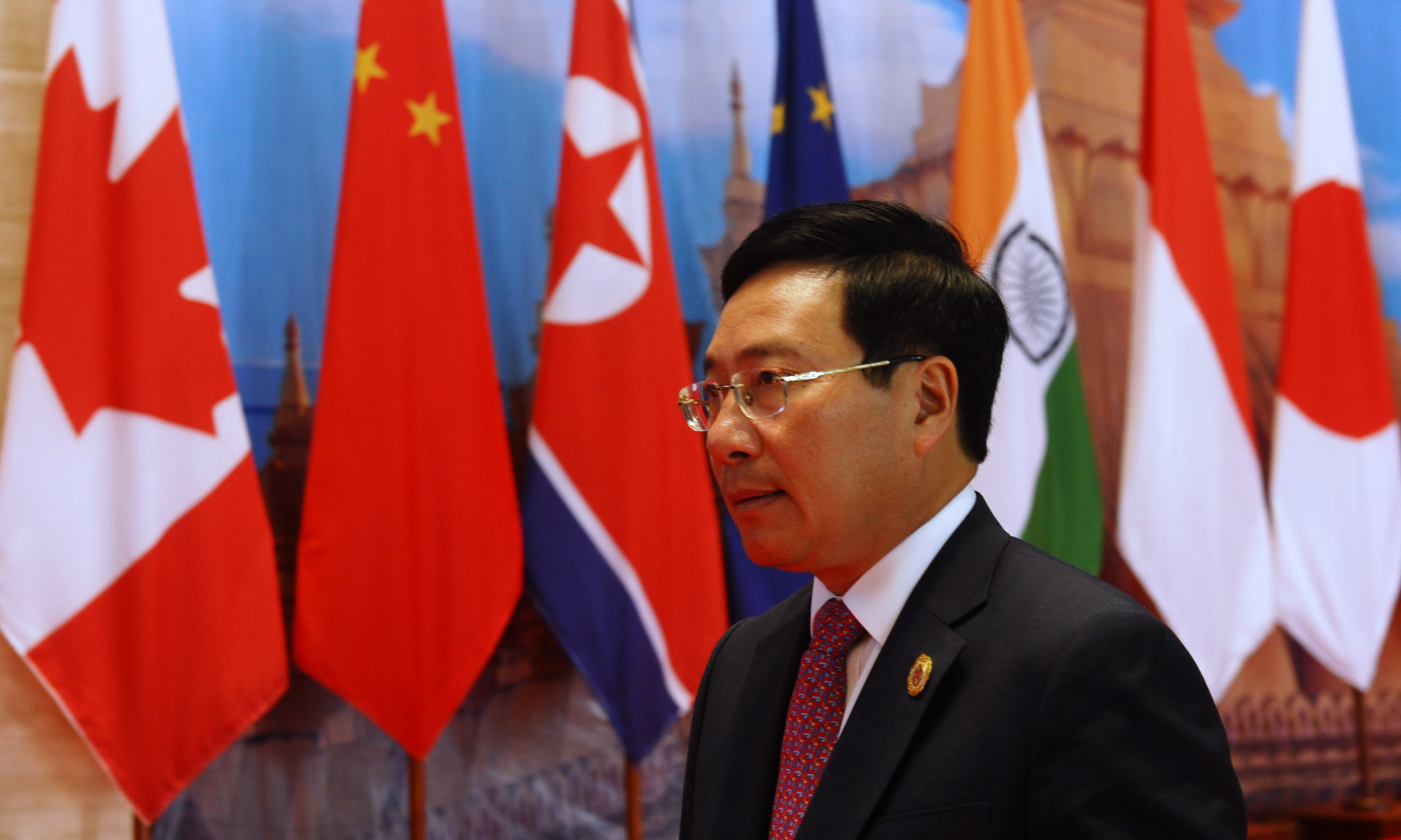 Vietnam's Foreign Minister Pham Binh Minh arrives to attend the planary session of the Association of Southeast Asian Nations' (ASEAN) 49th annual ministerial meeting in Vientiane on July 24, 2016. Southeast Asian foreign ministers were to hold crunch talks in communist Laos on July 24 at a summit already overshadowed by infighting over Beijing's sabre rattling in the South China Sea. / AFP PHOTO / HOANG DINH NAM