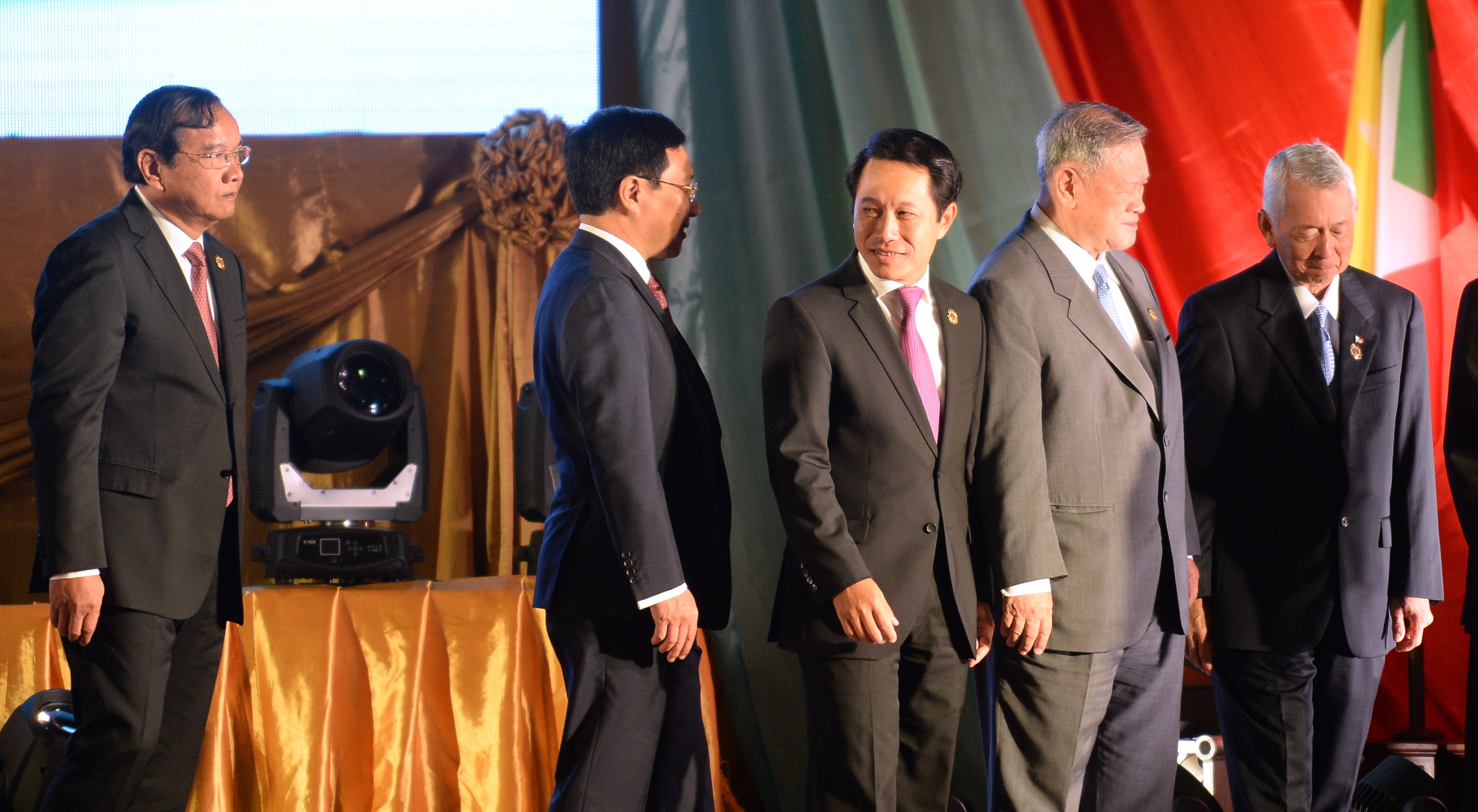 (L-R) Cambodia's Foreign Minister Prak Sokhonn, Vietnam's Foreign Minister Pham Binh Minh, Laos' Foreign Minister Saleumxay Kommasith, Brunei's Foreign Minister Dato Lim Jock Seng and Philippines' Foreign Minister Perfecto Yasay walk down from the podium after a group photo session during the opening ceremony of the Association of Southeast Asian Nations (ASEAN)'s 49th annual ministerial meeting in Vientiane on July 24, 2016. Southeast Asian foreign ministers were to hold crunch talks in communist Laos on July 24 at a summit already overshadowed by infighting over Beijing's sabre rattling in the South China Sea. / AFP PHOTO / HOANG DINH NAM