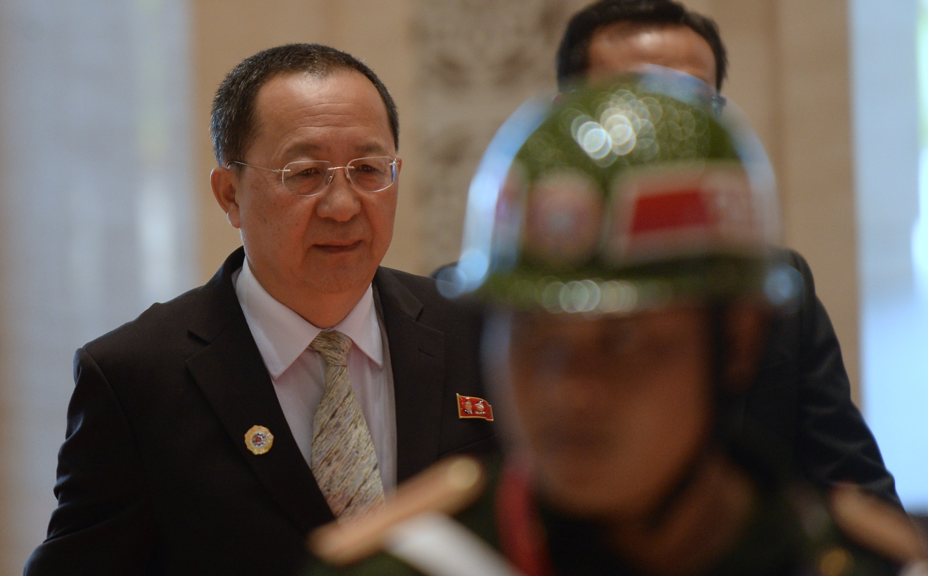 North Korea's new Foreign Minister Ri Yong-Ho (L) arrives at the main venue of the Association of Southeast Asian Nations (ASEAN) annual ministerial meeting and the Regional Security Forum in Vientiane on July 25, 2016. Southeast Asian nations were deadlocked on July 24 about how to confront China's territorial claims in the South China Sea as pressure from Beijing again drove a wedge between countries on the region's toughest security challenge. / AFP PHOTO / HOANG DINH NAM