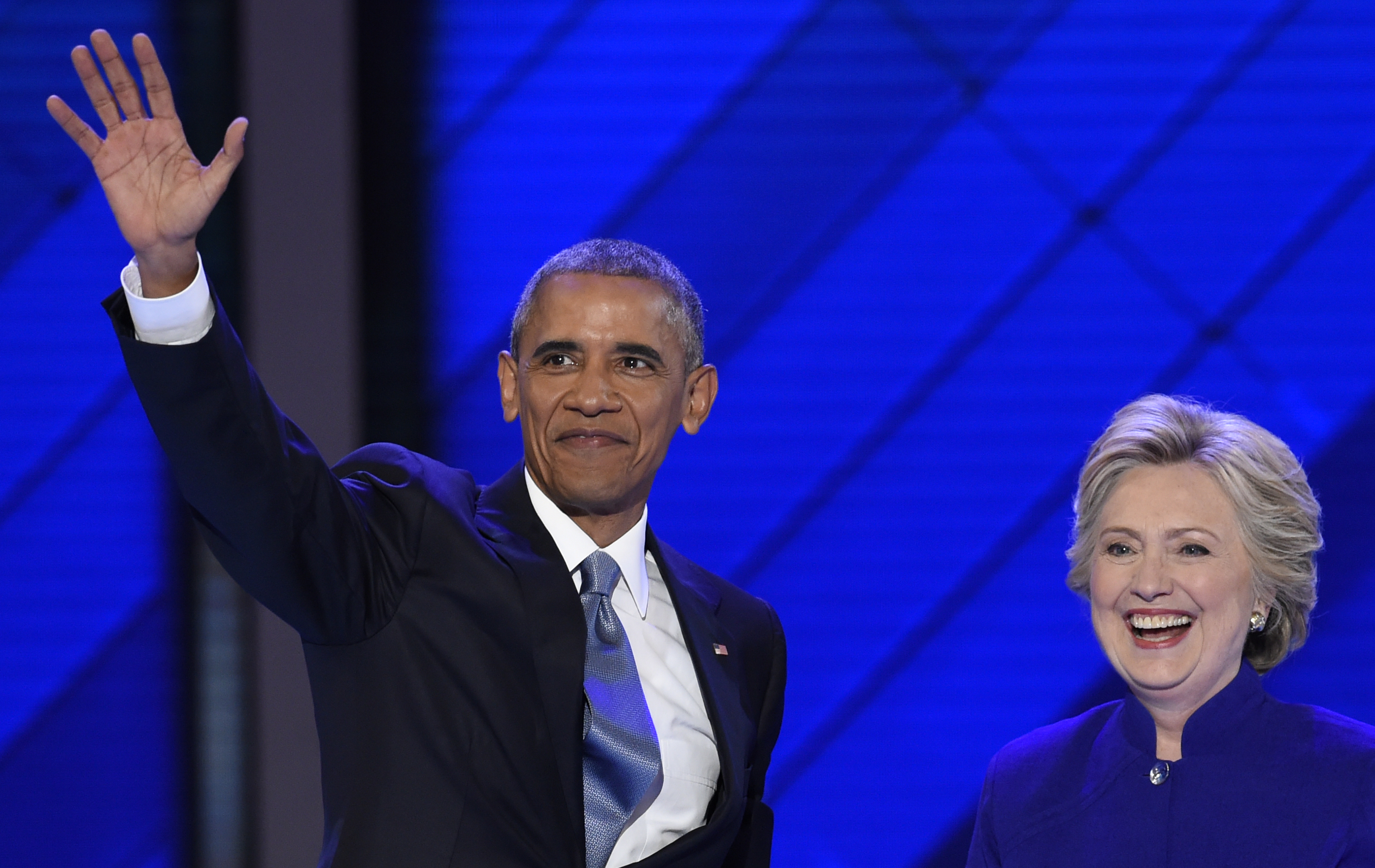 US President Barack Obama stands on stage with Democratic presidential nominee Hillary Clinton during Day 3 of the Democratic National Convention at the Wells Fargo Center, July 27, 2016 in Philadelphia, Pennsylvania.      / AFP PHOTO / SAUL LOEB