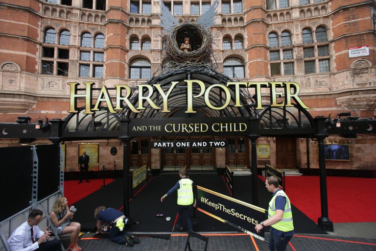 Workers make preparations at the entrance to the Palace Theatre ahead of the world premiere of the Harry Potter and the Cursed Child stage play in London on July 30, 2016. / AFP PHOTO / Daniel Leal-Olivas