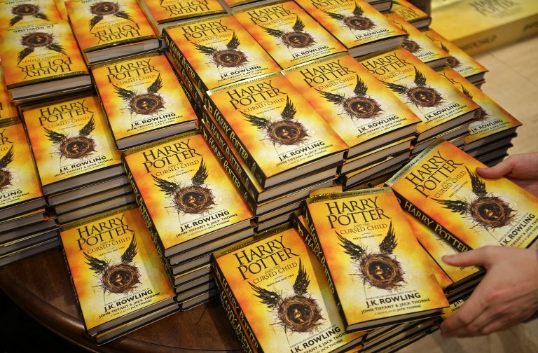 Piles of the new Harry Potter script book "Harry Potter and the Cursed Child Parts One & Two" are pictured inside Waterstones bookshop on Piccadilly in central London early in the morning of July 31, 2016, during the midnight party celebrating the publication of "Harry Potter and the Cursed Child Parts One & Two" script book. Harry Potter fans were buzzing with excitement Saturday as "Harry Potter and the Cursed Child", a stage play that imagines the fictional boy wizard as a grown-up father of three, opened in London. The script will be released in Britain at midnight on Saturday (2300 GMT), with bookshops planning to stay open into the wee small hours to satisfy the desires of Potter fans. July 31 is the birthday of both Rowling and Potter. / AFP PHOTO / Daniel Leal-Olivas