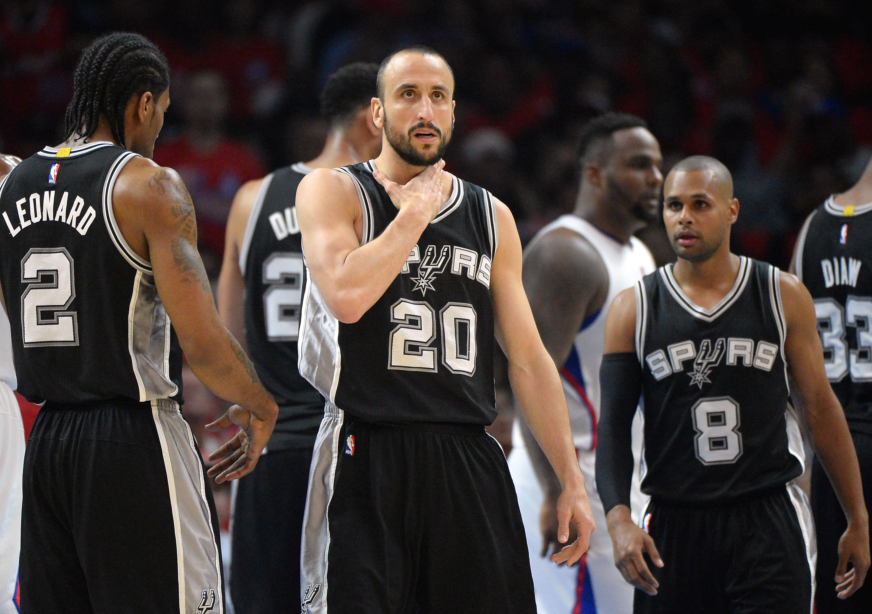 LOS ANGELES, CA - APRIL 22: Manu Ginobili #20 of the San Antonio Spurs reaches for his neck after a foul from Matt Barnes #22 of the Los Angeles Clippers during the first half of Game Two of the Western Conference quarterfinals of the 2015 NBA Playoffs at Staples Center on April 22, 2015 in Los Angeles, California. NOTE TO USER: User expressly acknowledges and agrees that, by downloading and or using this Photograph, user is consenting to the terms and condition of the Getty Images License Agreement.   Harry How/Getty Images/AFP