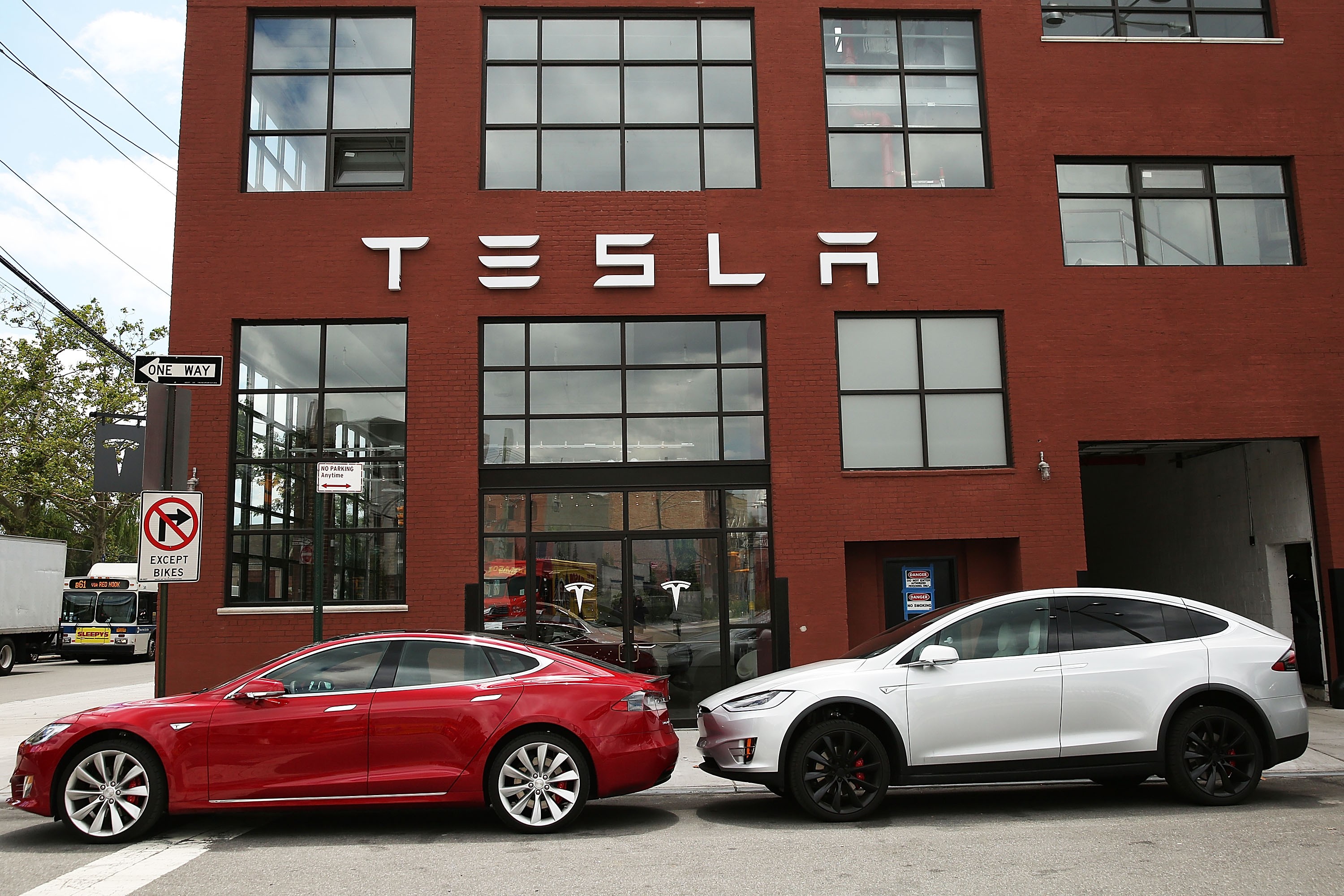 NEW YORK, NY - JULY 05: Tesla vehicles sit parked outside of a new Tesla showroom and service center in Red Hook, Brooklyn on July 5, 2016 in New York City. The electric car company and its CEO and founder Elon Musk have come under increasing scrutiny following a crash of one of its electric cars while using the controversial autopilot service. Joshua Brown crashed and died in Florida on May 7 in a Tesla car that was operating on autopilot, which means that Brown's hands were not on the steering wheel. Spencer Platt/Getty Images/AFP