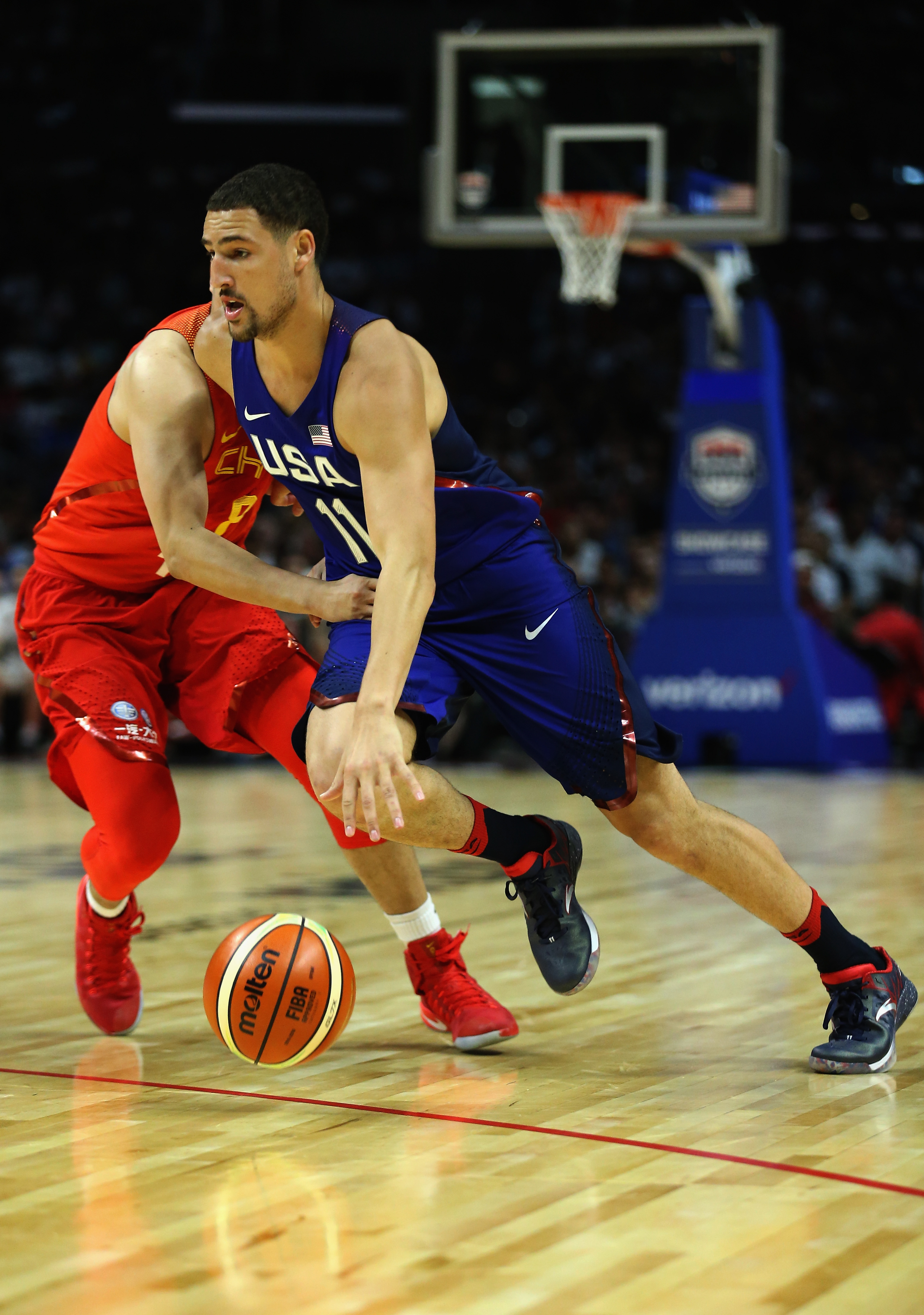 LOS ANGELES, CA - JULY 24: Klay Thompson #11 of the United States drives to the basket against Ding Yanyuhang #8 of China during the second half of a USA Basketball showcase exhibition game at Staples Center on July 24, 2016 in Los Angeles, California.   Sean M. Haffey/Getty Images/AFP