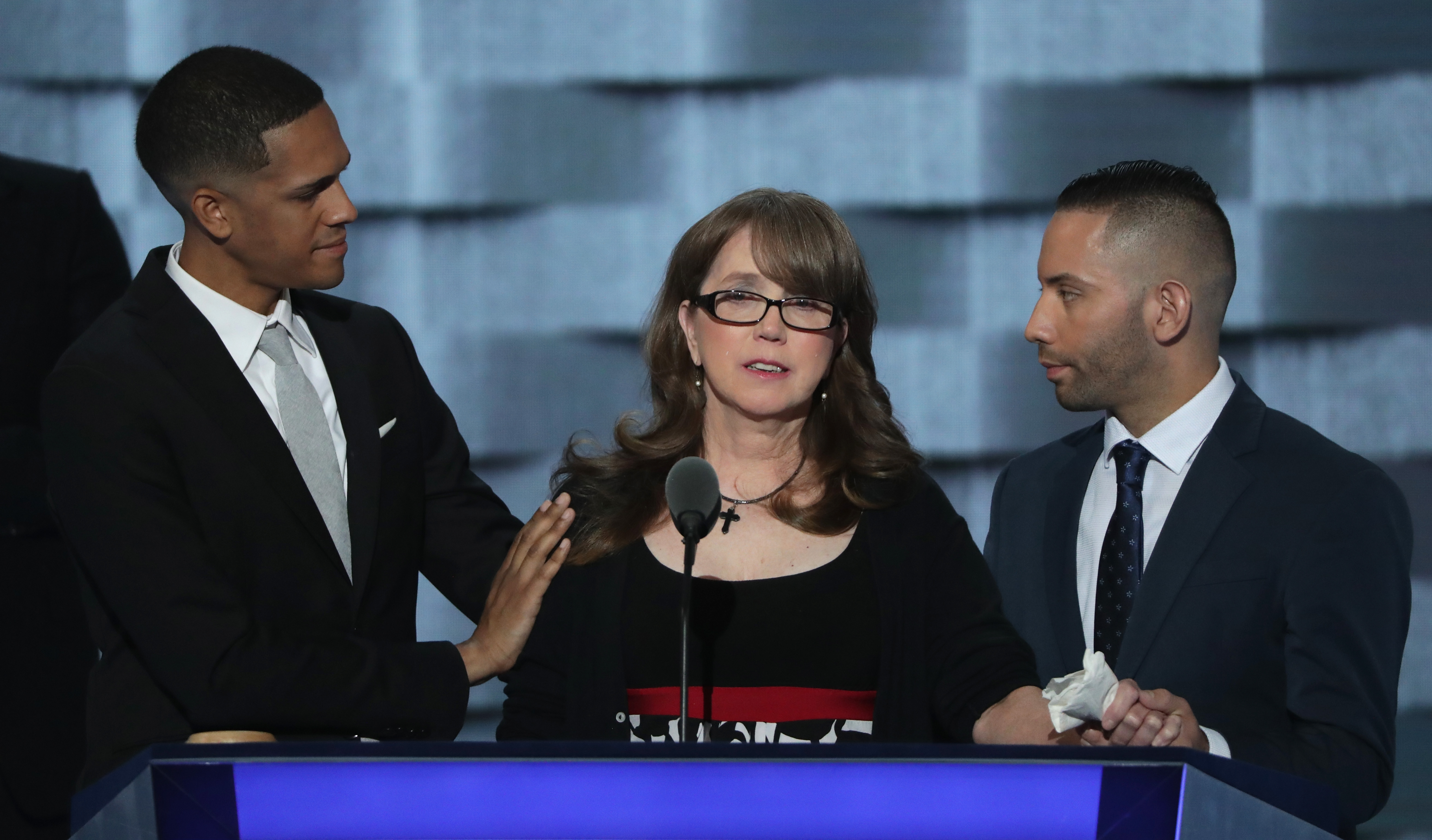 PHILADELPHIA, PA - JULY 27: Christine Leinonen, mother of Christopher 'Dru' Leinonen, is comforted by Brandon Wolf (L) and Jose Arriagada (R), survivors of the attack at the Pulse nightclub in Orlando, as they stand on stage during the third day of the Democratic National Convention at the Wells Fargo Center, July 27, 2016 in Philadelphia, Pennsylvania. Democratic presidential candidate Hillary Clinton received the number of votes needed to secure the party's nomination. An estimated 50,000 people are expected in Philadelphia, including hundreds of protesters and members of the media. The four-day Democratic National Convention kicked off July 25.   Alex Wong/Getty Images/AFP