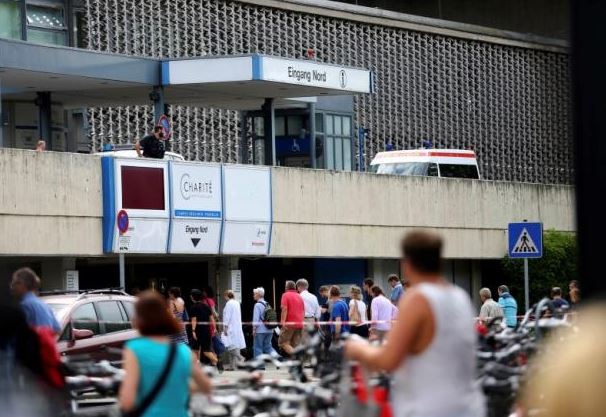 People return to the university clinic in Steglitz, a southwestern district of Berlin, July 26, 2016 after a doctor had been shot at and the gunman had killed himself. Reuters/Hannibal Hanschke 