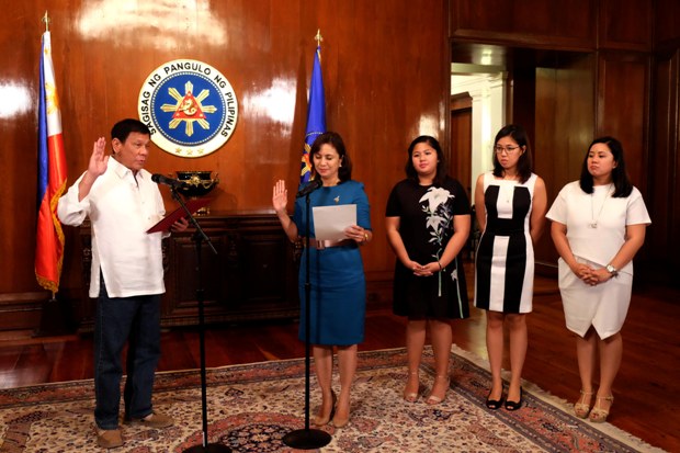 President Rodrigo R. Duterte administers the oath of office to Vice-President Maria Leonor G. Robredo, during her inauguration as Housing and Urban Development Coordinating Council (HUDCC) Secretary at the Malacañan Palace on July 12. Also in the photo are Robredo’s daughters, Jillian, Janine and Jessica. KIWI BULACLAC/PPD
