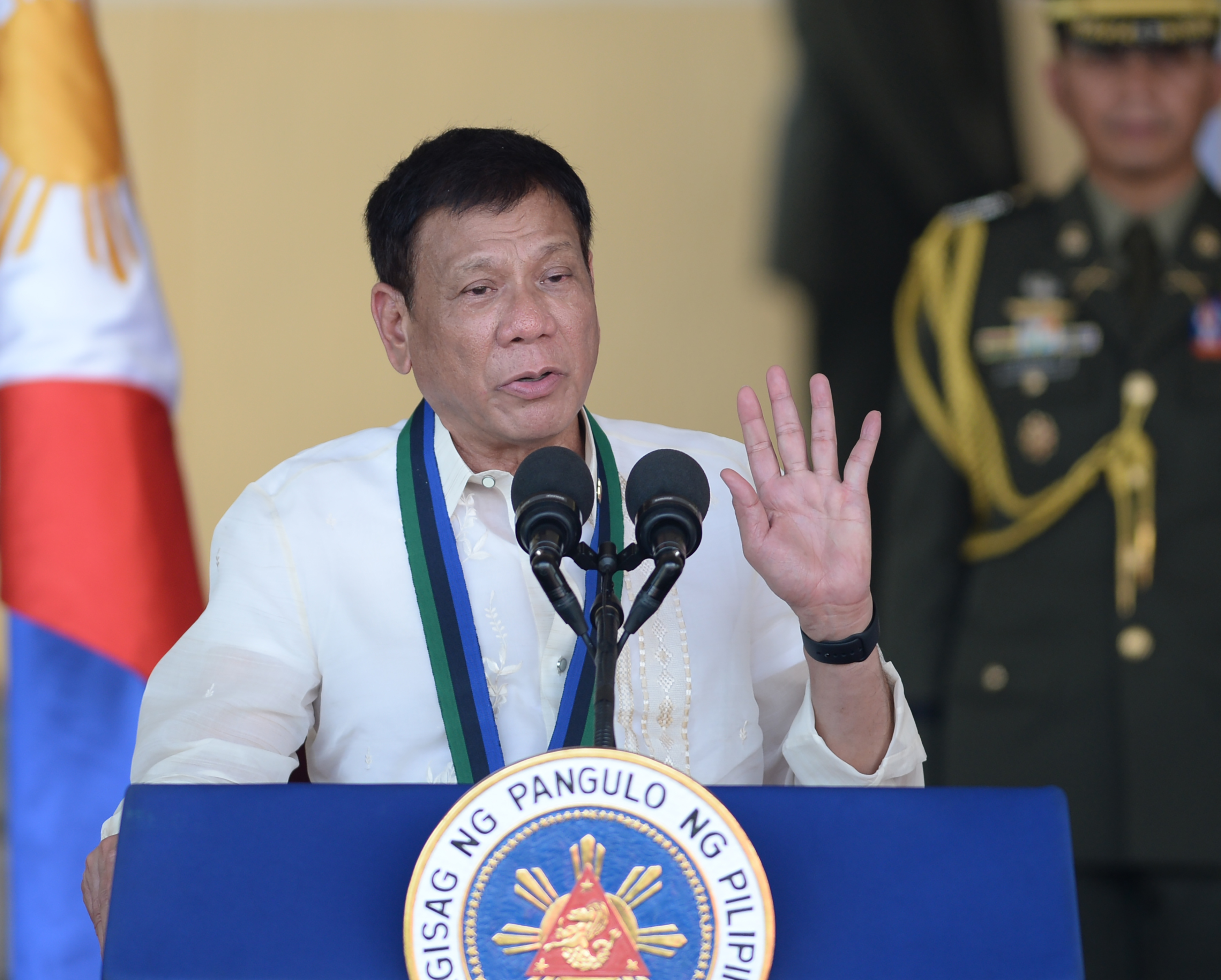 Philippines President Rodrigo Duterte gestures as he delivers his speech during a military parade at the military headquarters in Manila on July 1, 2016. Duterte was sworn in as the Philippines' president June 30 -- and quickly launched a foul-mouthed vow to wipe out drug traffickers and even urged ordinary Filipinos to kill addicts. / AFP PHOTO / TED ALJIBE