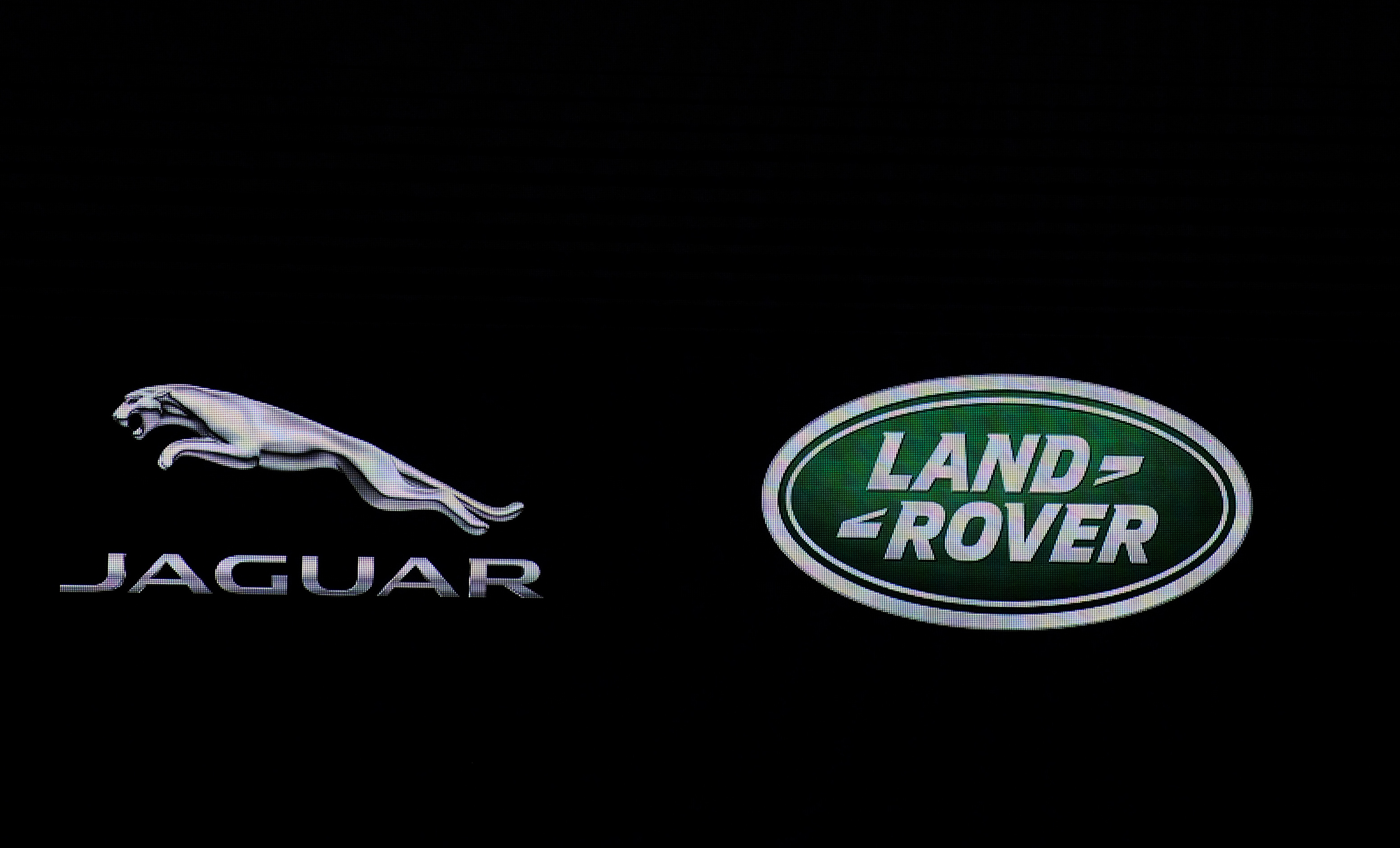 (FILES) This file photo taken on February 3, 2016 shows the Jaguar and Land Rover logo  seen at the Indian Auto Expo 2016 in Greater Noida on the outskirts of New Delhi. Jaguar Land Rover announced TAugust 4, 2016 it is recalling more than 50,000 vehicles in the United States to fix defective Takata airbags.The British luxury carmaker, part of Indian giant Tata Motors, said it has begun sending recall notifications to owners of certain 2009-2011 Jaguar XF vehicles and 2007-2011 Land Rover Range Rover vehicles.  / AFP PHOTO / SAJJAD HUSSAIN