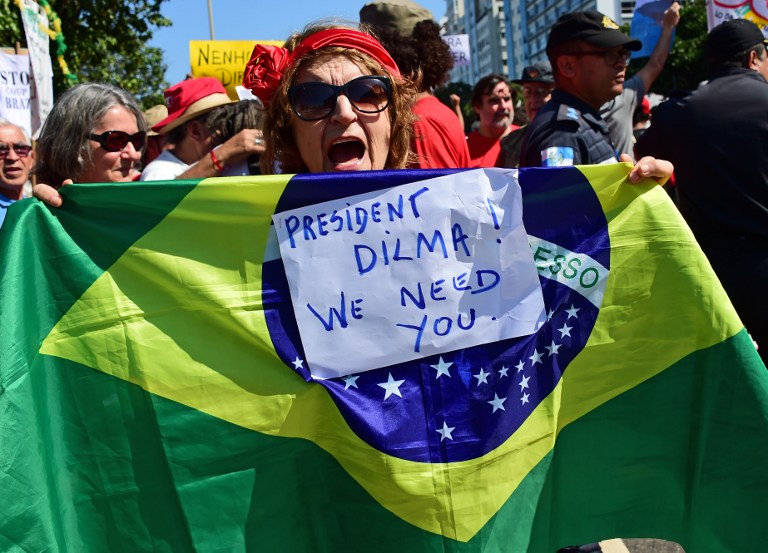 Residents of Rio de Janeiro demonstrate against interim president Michel Temer, political upheaval, corruption and the cost of the Rio 2016 Olympics Games, in front of the Copacabana Palace Hotel on August 5, 2016. Thousands of Brazilians angry at political upheaval, corruption and the cost of the Rio Olympics blocked traffic in protests hours before the gala opening ceremony. Most people came to vent anger at center-right interim president Michel Temer who took power in May on the suspension of the elected leftist president, Dilma Rousseff, for an impeachment trial that her supporters claim amounts to a coup. / AFP PHOTO / TASSO MARCELO