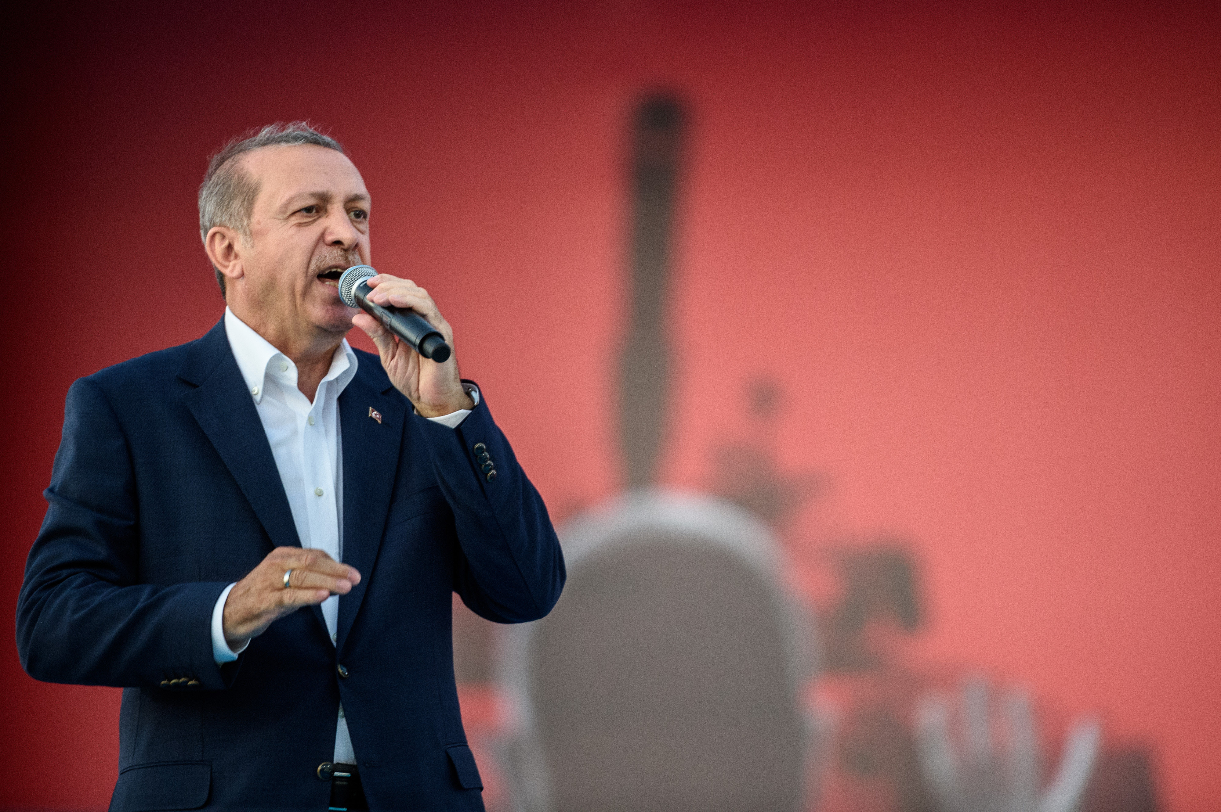 Turkish President Recep Tayyip Erdogan speaks on August 7, 2016 in Istanbul during a rally against the failed military coup on July 15.  Hundreds of thousands of people gathered in Istanbul for a pro-democracy rally organised by the ruling party, bringing to an end three weeks of demonstrations in support of President Recep Tayyip Erdogan after last month's failed coup.  / AFP PHOTO / OZAN KOSE