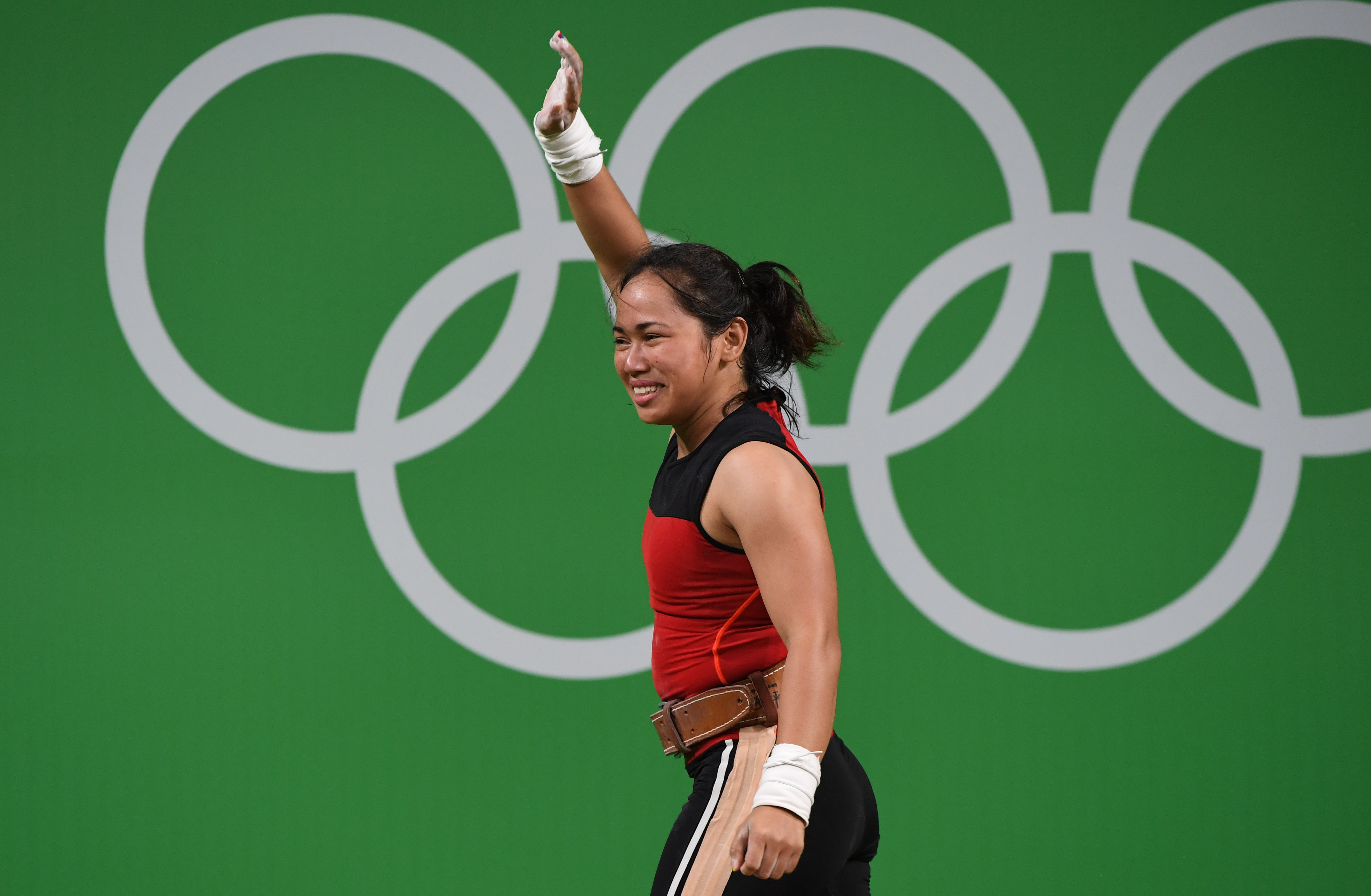 Philippines' Hidilyn Diaz celebrates during the women's 53kg weightlifting event at the Rio 2016 Olympic games in Rio de Janeiro on August 7, 2016. / AFP PHOTO / GOH Chai Hin
