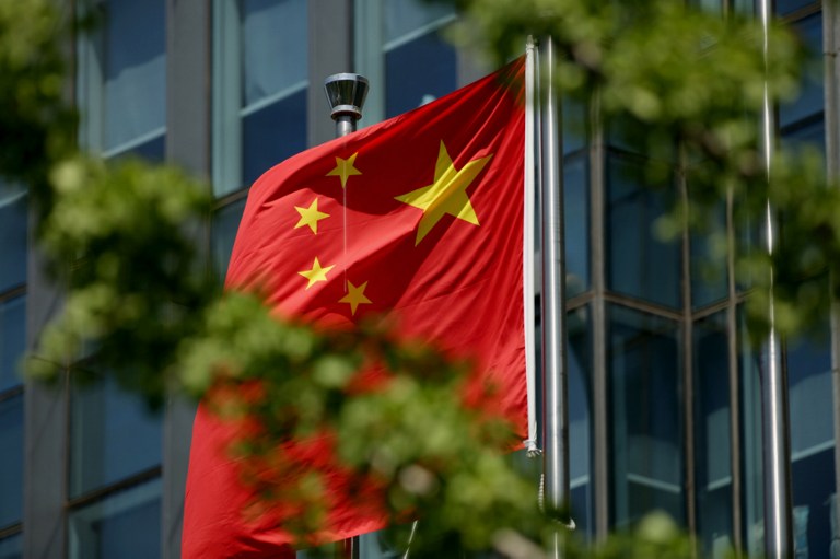 The Chinese national flag is seen on a flagpole in Beijing on August 8, 2016.  Most of the five stars on the Chinese flags being used at medal ceremonies at the Rio Olympics are misaligned, officials said, prompting a diplomatic protest and online fury. / AFP PHOTO / STR