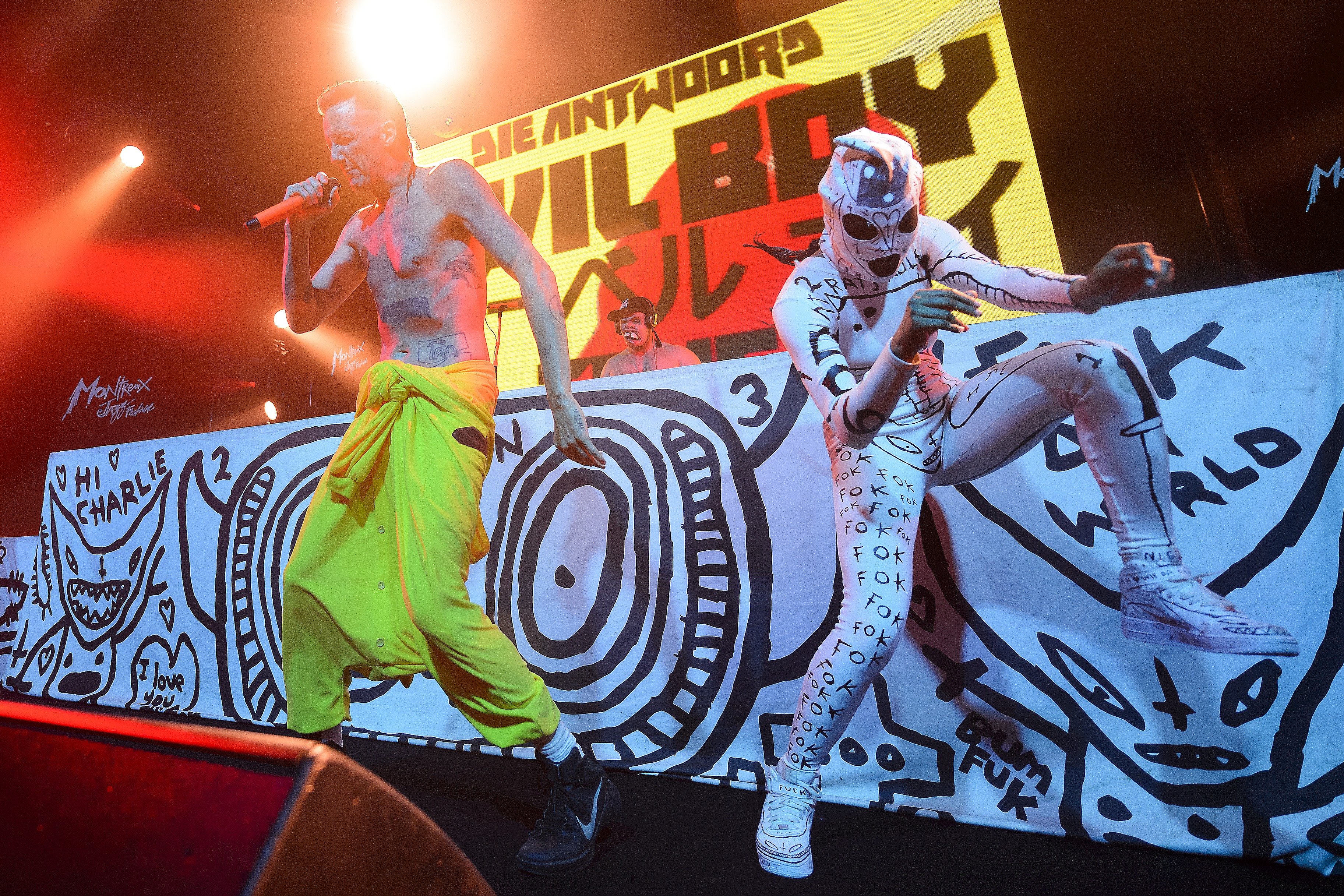 (FILES) This file photo taken on July 06, 2015 shows lead vocalist Watkin Tudor Jones (AKA Ninja) (L) of the South African rap-rave group Die Antwoord performing with a dancer at the Montreux Jazz lab stage during the 49th Montreux Jazz Festival. South African band Die Antwoord accused "Suicide Squad" director David Ayer on August 11, 2016 of ripping off / AFP PHOTO / FABRICE COFFRINI