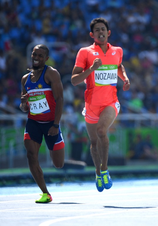 Japan's Keisuke Nozawa (R) and Philippines' Eric Cray compete in the Men's 400m Hurdles Round 1 during the athletics event at the Rio 2016 Olympic Games at the Olympic Stadium in Rio de Janeiro on August 15, 2016.   / AFP PHOTO / OLIVIER MORIN
