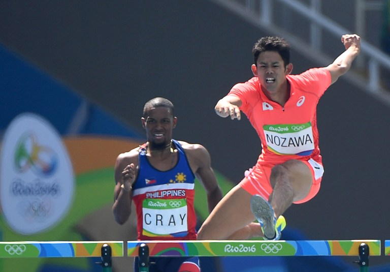 Japan's Keisuke Nozawa (R) and Philippines' Eric Cray compete in the Men's 400m Hurdles Round 1 during the athletics event at the Rio 2016 Olympic Games at the Olympic Stadium in Rio de Janeiro on August 15, 2016.   / AFP PHOTO / OLIVIER MORIN