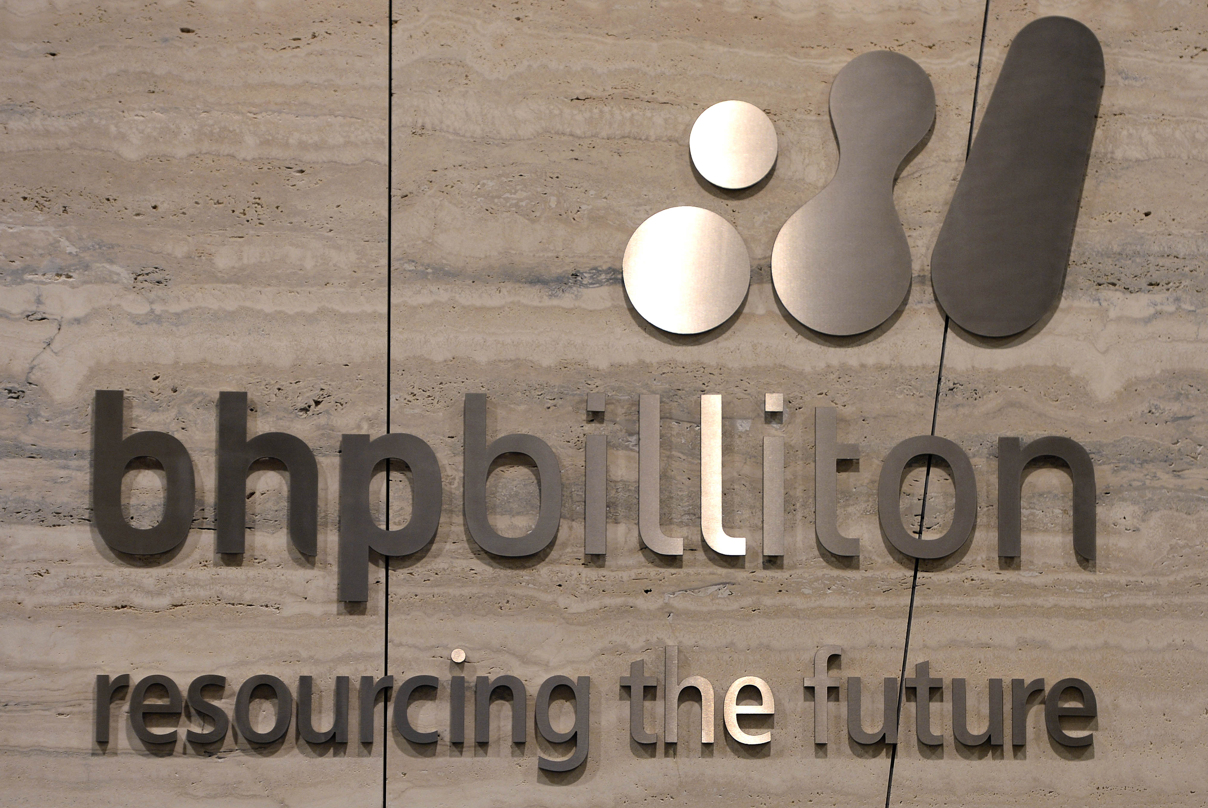 (FILES) This file photo taken on February 18, 2014 shows the sign of the BHP Billiton business centre in Melbourne. BHP Billiton reported an annual net loss of USD 6.39 billion on August 16, 2016 its worst-ever result, as the impact of a fatal mine dam disaster in Brazil and weak commodity prices hit the world's biggest miner. / AFP PHOTO / MAL FAIRCLOUGH
