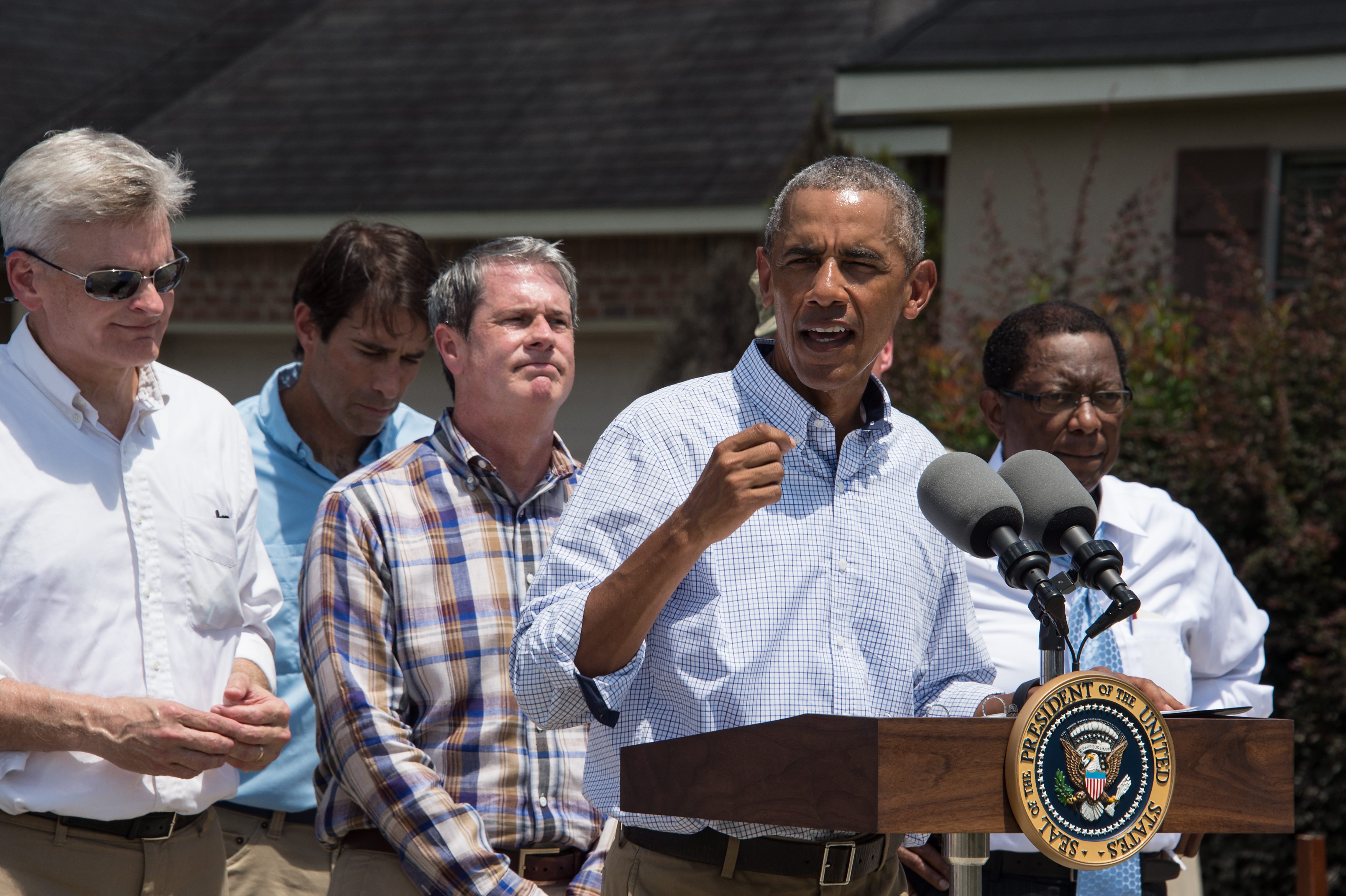 US President Barack Obama speaks after touring a flood-affected area in Baton Rouge, Louisiana, on August 23, 2016. / AFP PHOTO / NICHOLAS KAMM