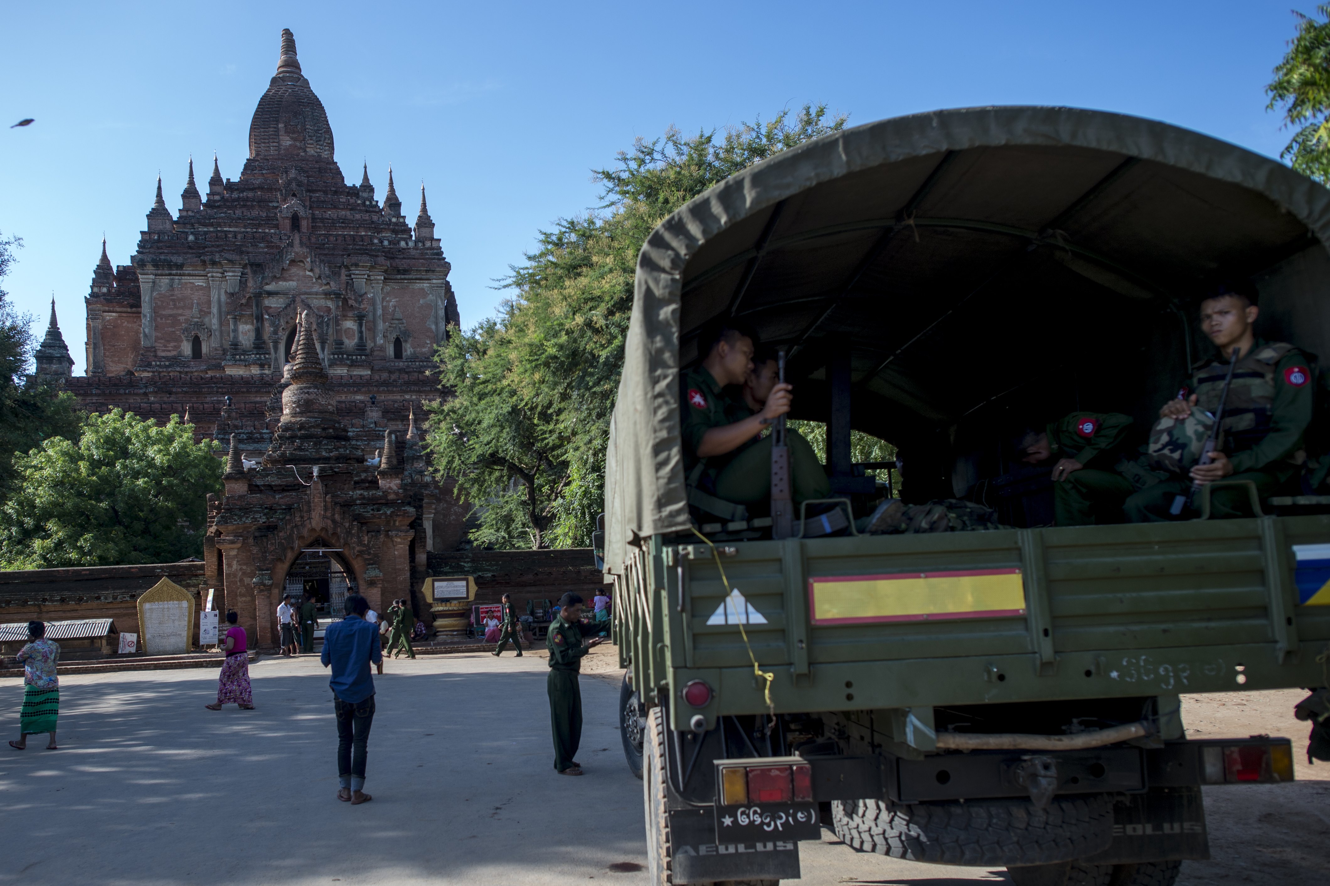 Myanmar military staff sit in a truck outside the damaged ancient Htilominlo Temple on August 25, 2016, after a 6.8 magnitude earthquake hit Bagan. A powerful 6.8 magnitude earthquake struck central Myanmar on August 24, killing at least three people and damaging nearly 200 pagodas in the famous ancient capital of Bagan, officials said. The quake, which the US Geological Survey said hit at a depth of 84 kilometres (52 miles), was also felt across neighbouring Thailand, India and Bangladesh, sending panicked residents rushing onto the streets. / AFP PHOTO / YE AUNG THU