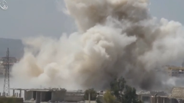 Activist video purports to show a government helicopter dropping bombs on rebel territory in the Damascus suburbs. (Photo captured from Reuters video)
