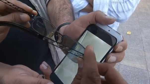 A Kurdish inventor builds a secret screen for the iPhone that enables only the user to see the contents by wearing special glasses. (Photo captured from Reuters video)