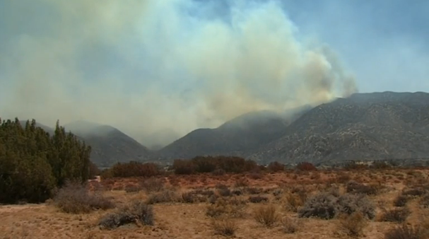 Wildfire in mountains east of Los Angeles grows in size and intensity. (Photo captured from Reuters video)